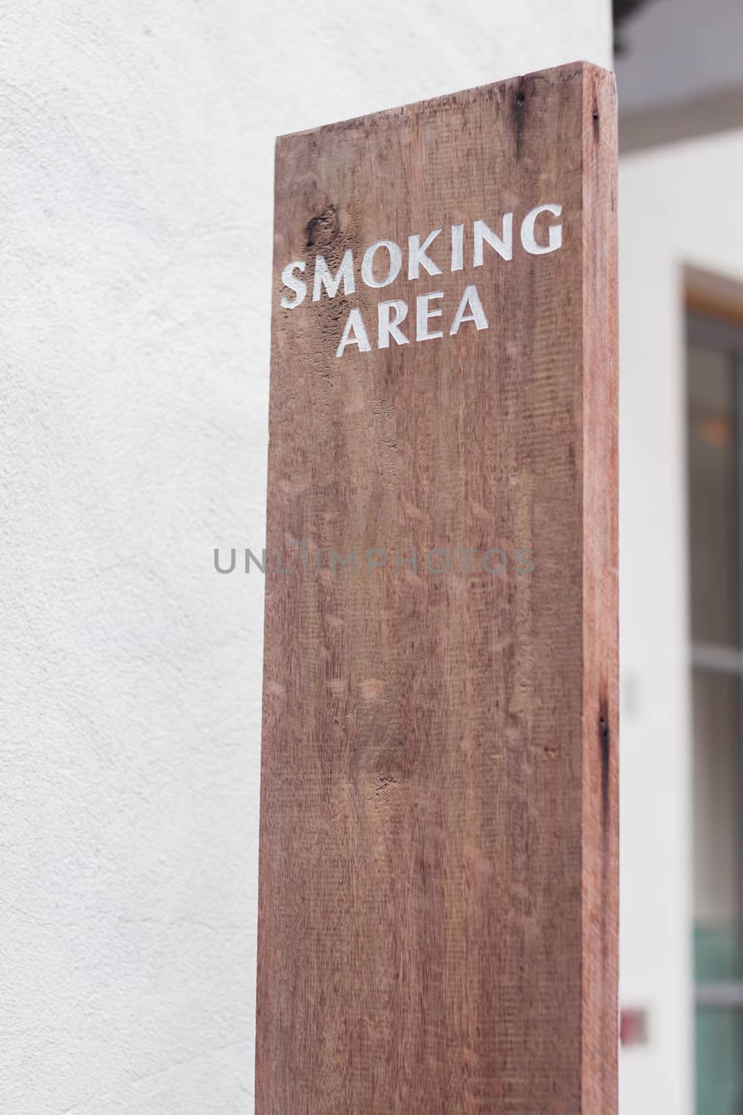 Smoking sign area on wooden plate, stock photo