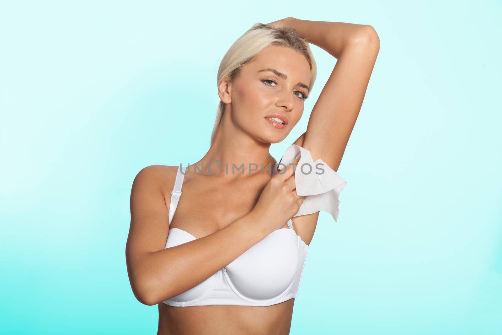 Higiene - young woman wiping the armpit with wet wipes, perspiration, sweat