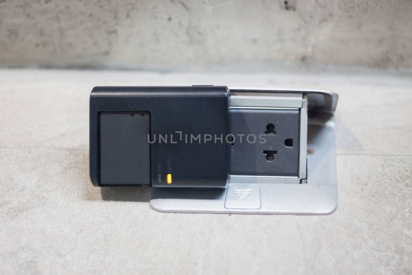 Charging battery on the floor, stock photo