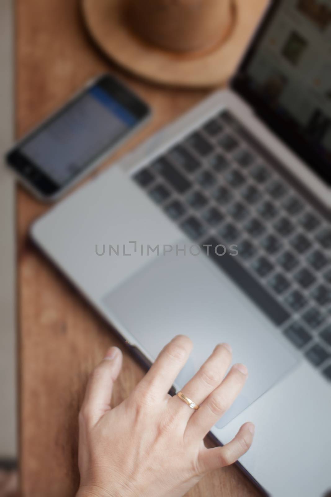 Woman working on computer in coffee shop, stock photo