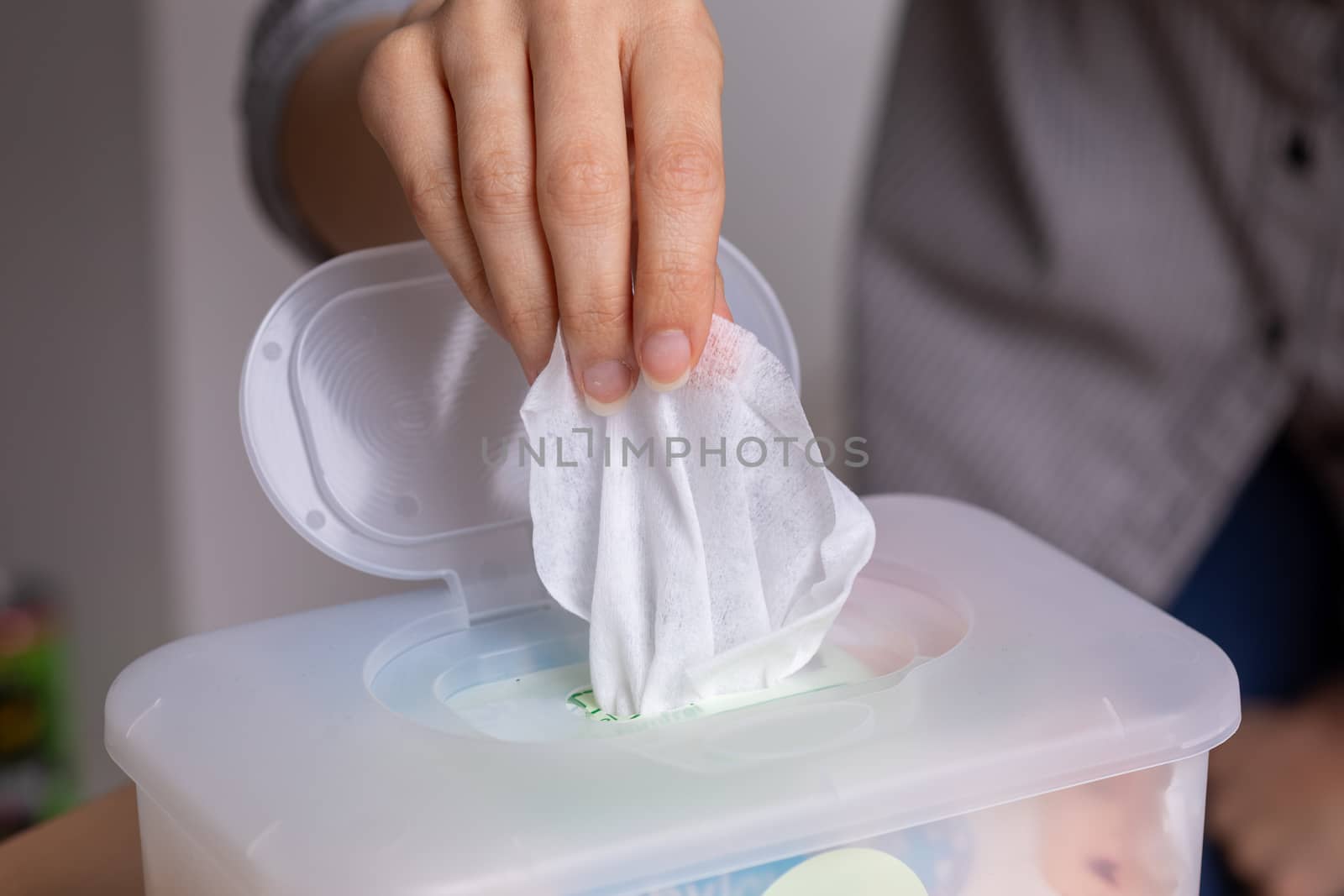 Wet wipes are universal an practical: woman take one wipe from b by adamr