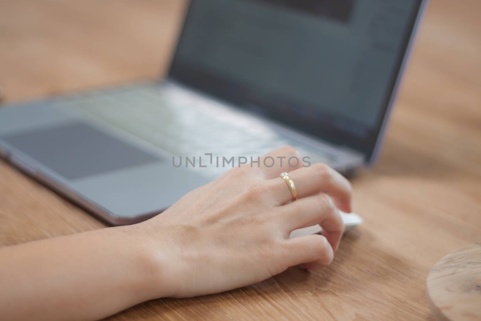 Woman working on computer in coffee shop, stock photo