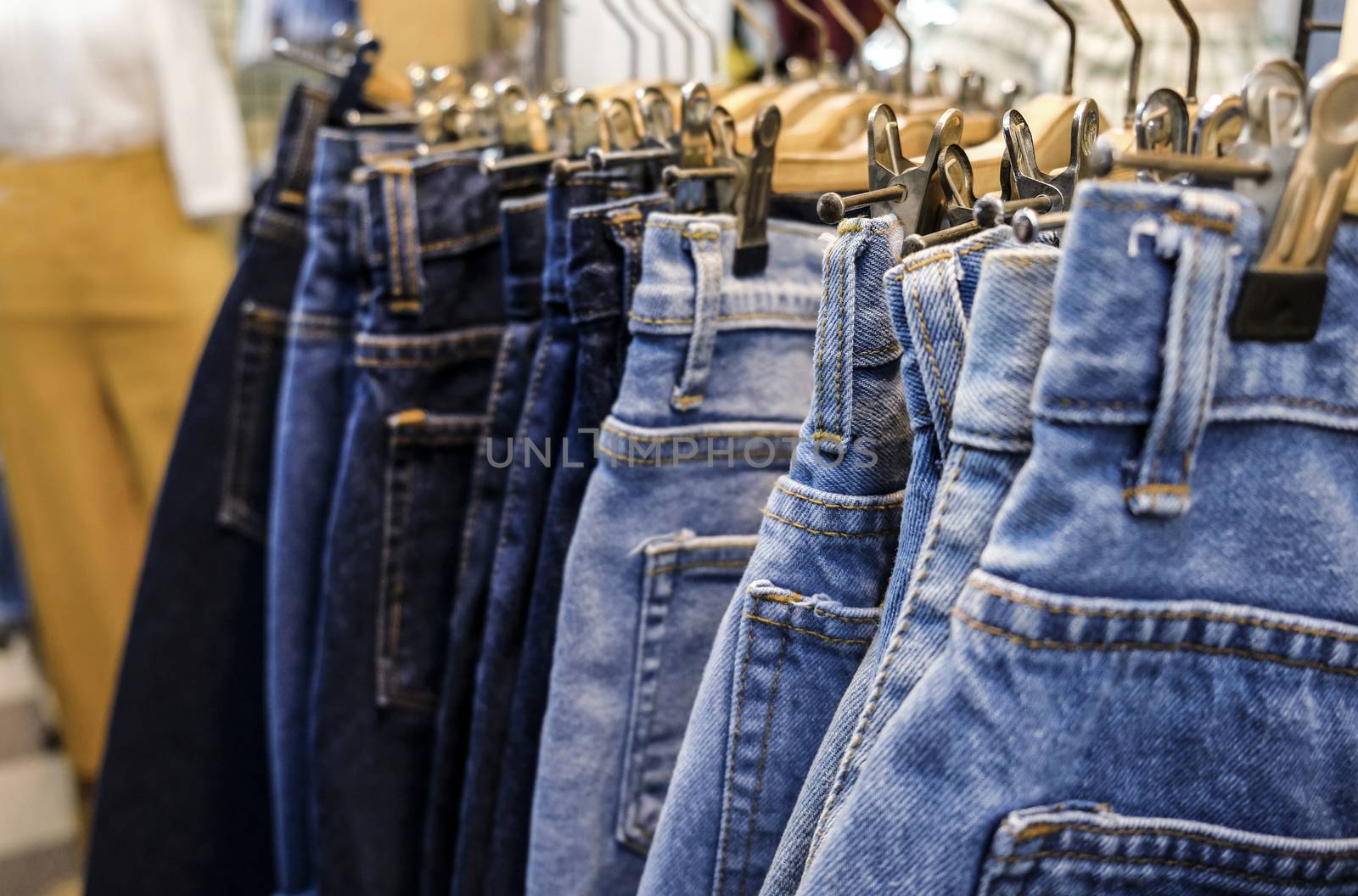 Row of hanged blue jeans skirts in shop