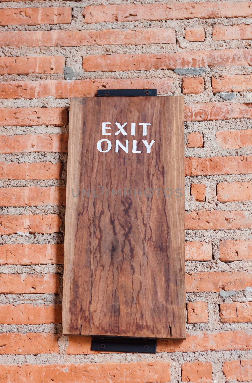 Exit only sign on brick wall, stock photo