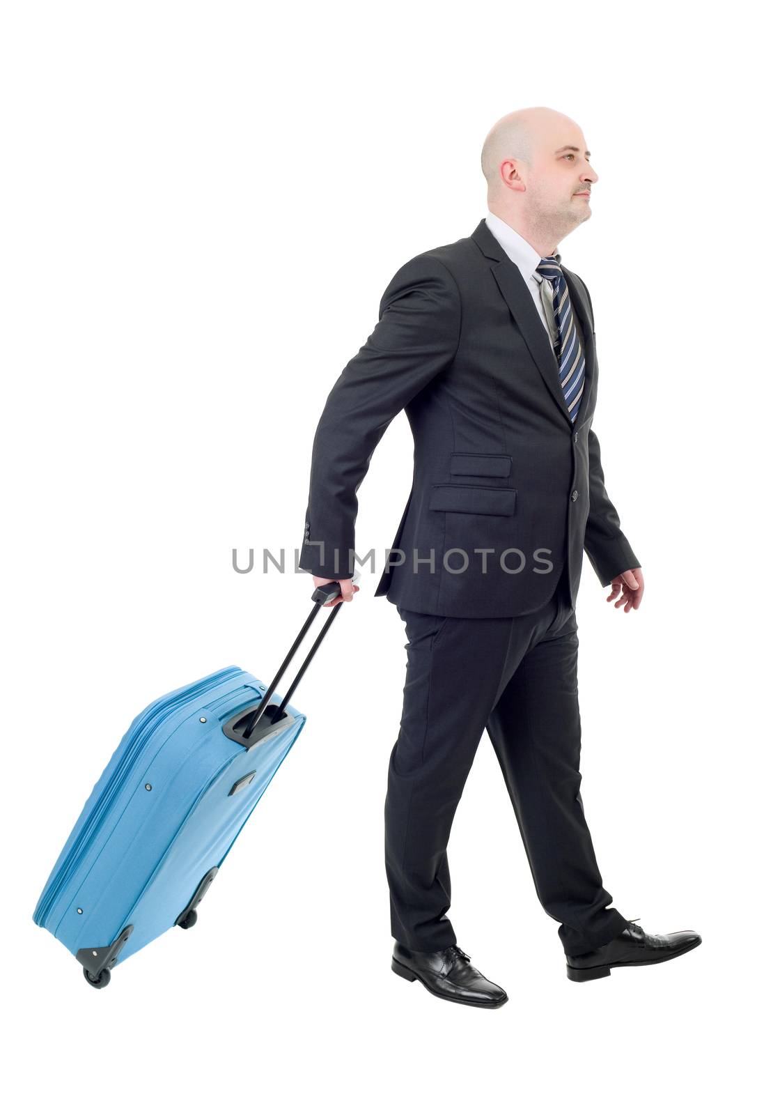 Full length side view of young businessman with luggage walking isolated on white background