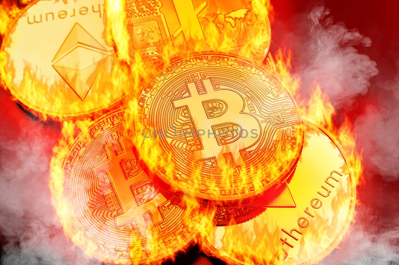 Conceptual picture of cryptocurrency coins bursting into flammes, illustrating crypto-currency market crash