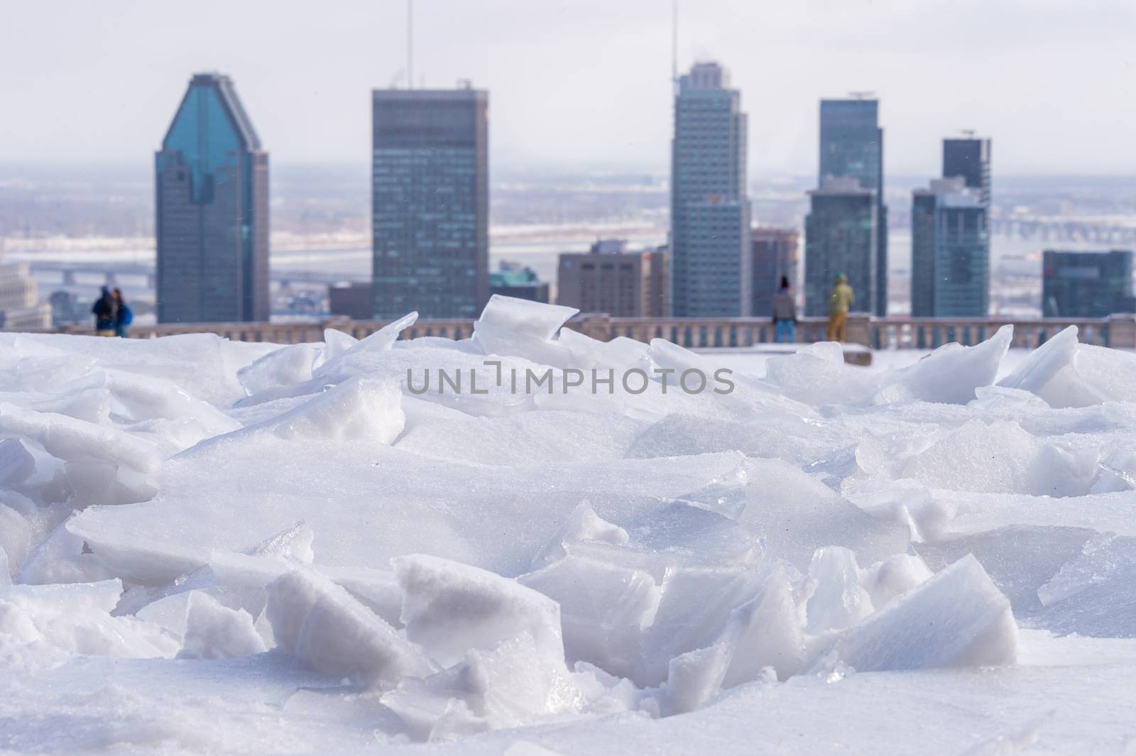Broken ice after freezing rain and Montreal skyline in background.