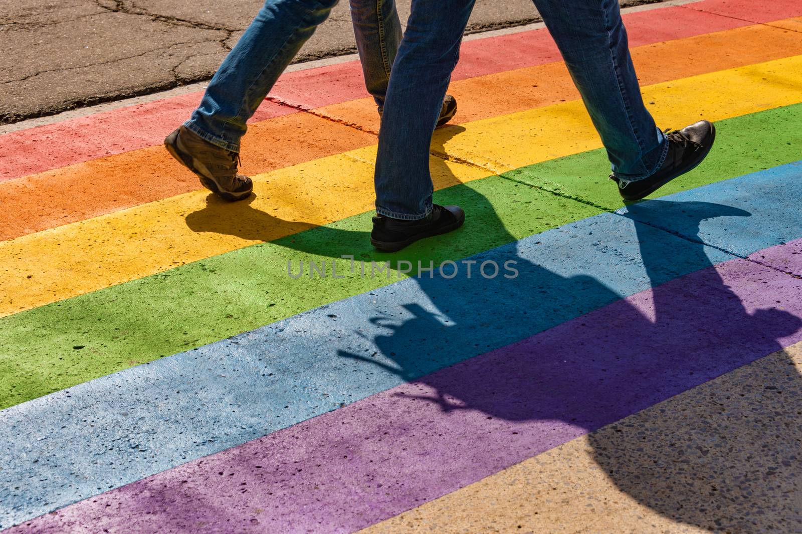 People walking on gay rainbow crosswalk in Montreal by mbruxelle