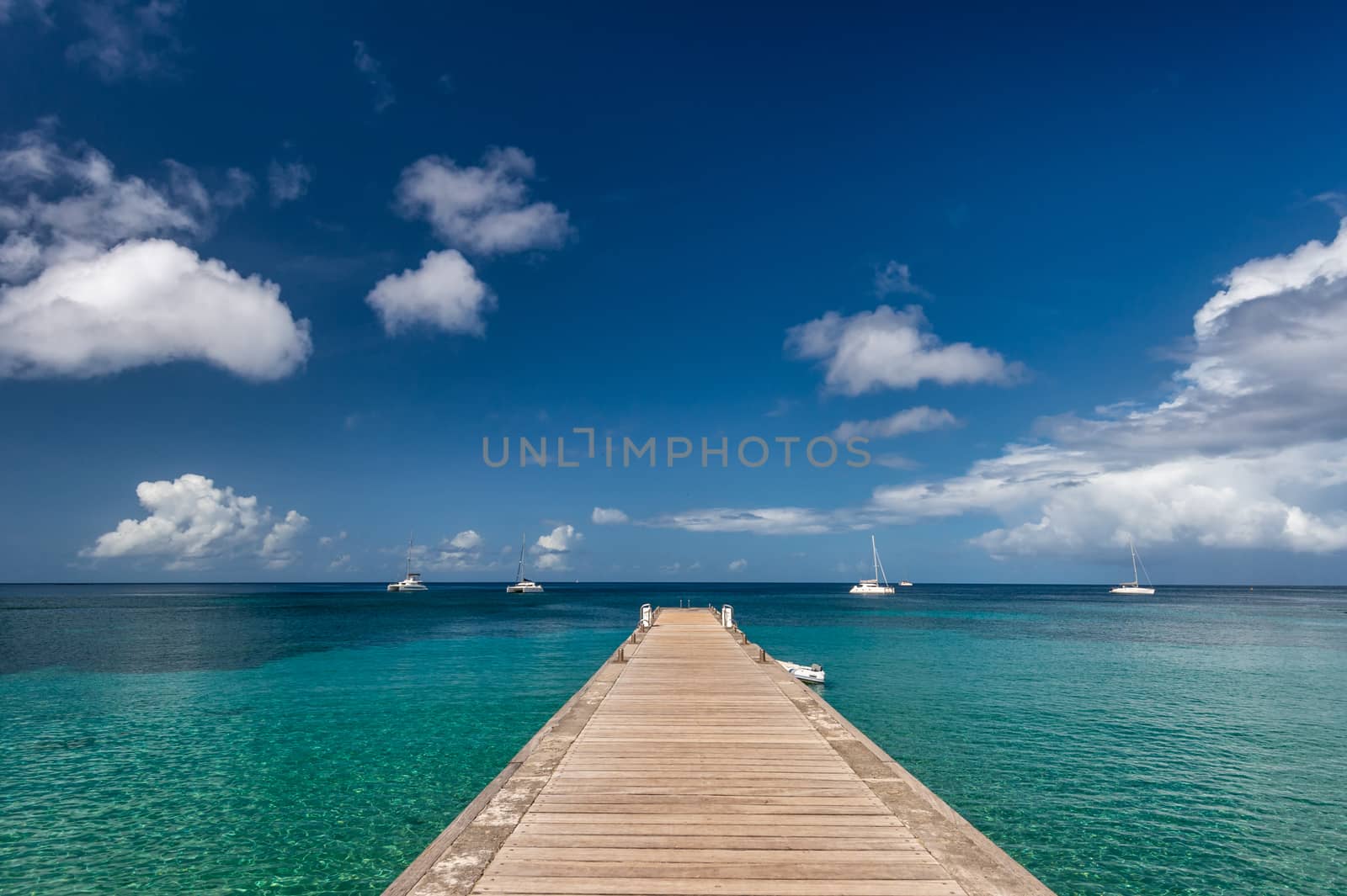 Wood pontoon and turquoise water at Petite Anse in Martinique