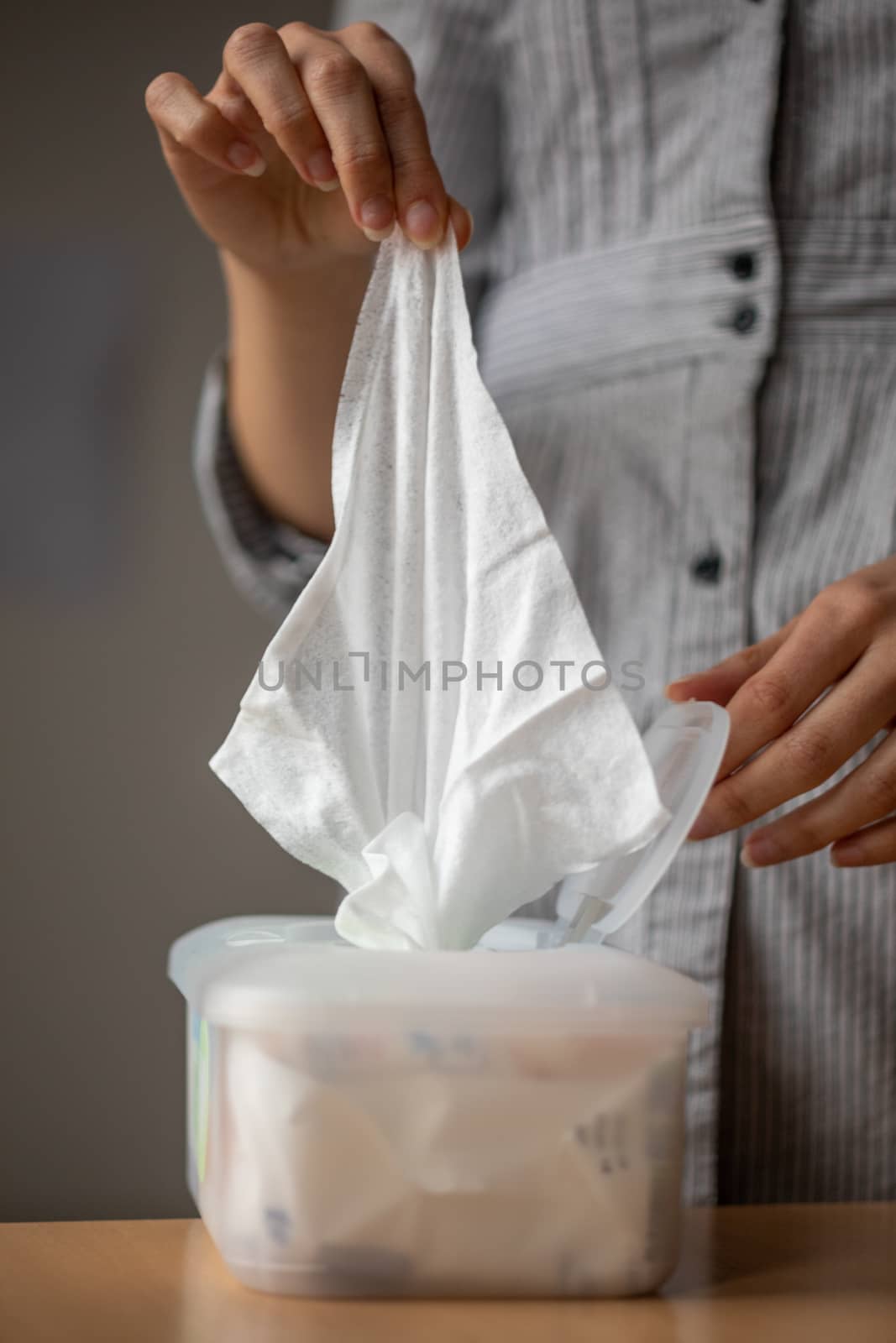 Wet wipes are universal an practical: woman take one wipe from b by adamr