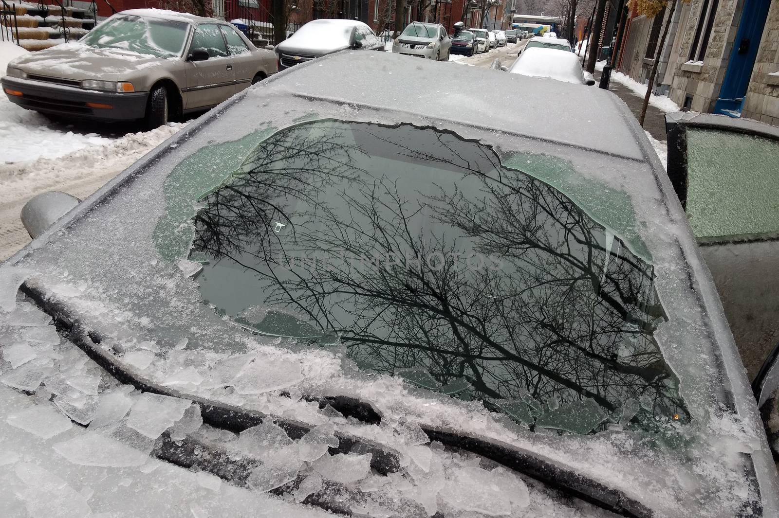 Thick layer of ice covering car after freezing rain in Montreal, by mbruxelle