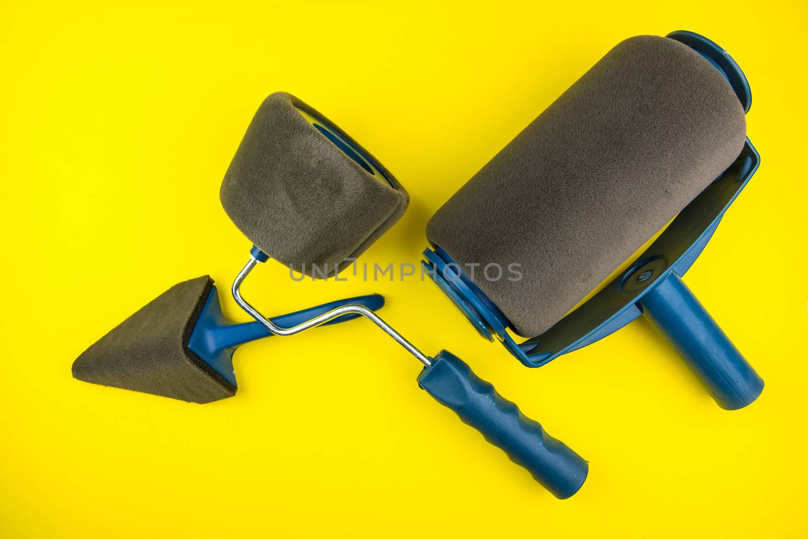 Top view of Paint roller set on yellow background with copy spac by Bubbers