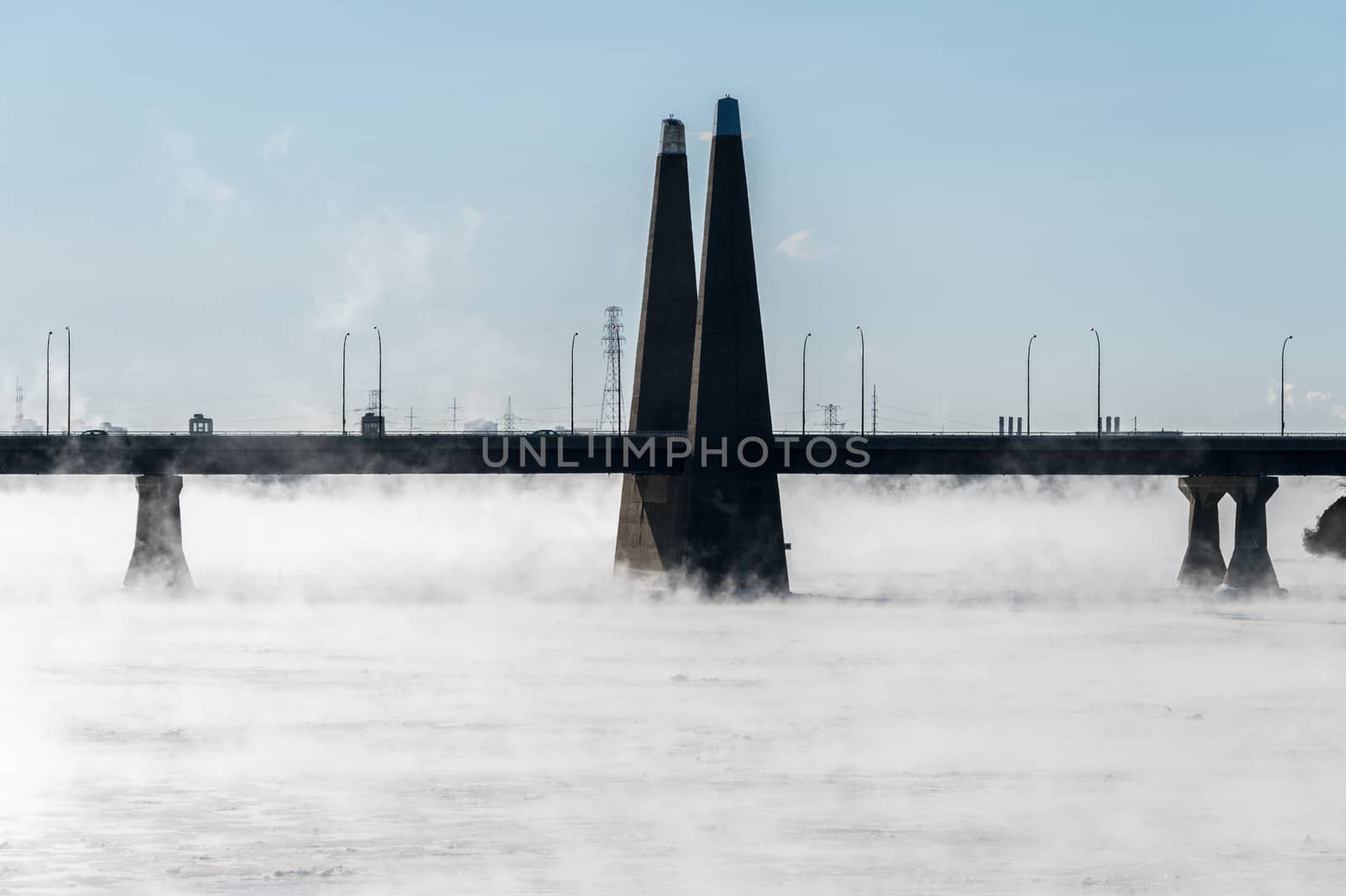 Montreal, CA - 1 January 2018: Pont de la Concorde as ice fog rises off the St. Lawrence River