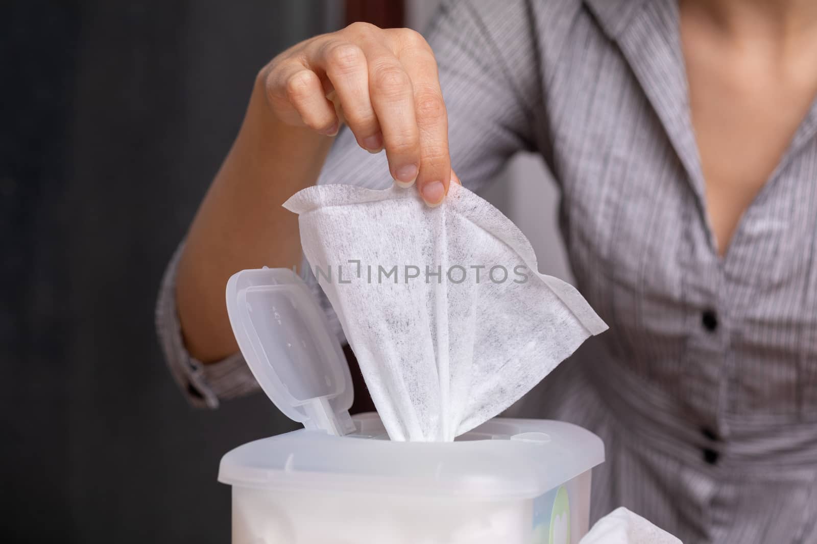 Wet wipes are universal an practical: woman take one wipe from b by adamr
