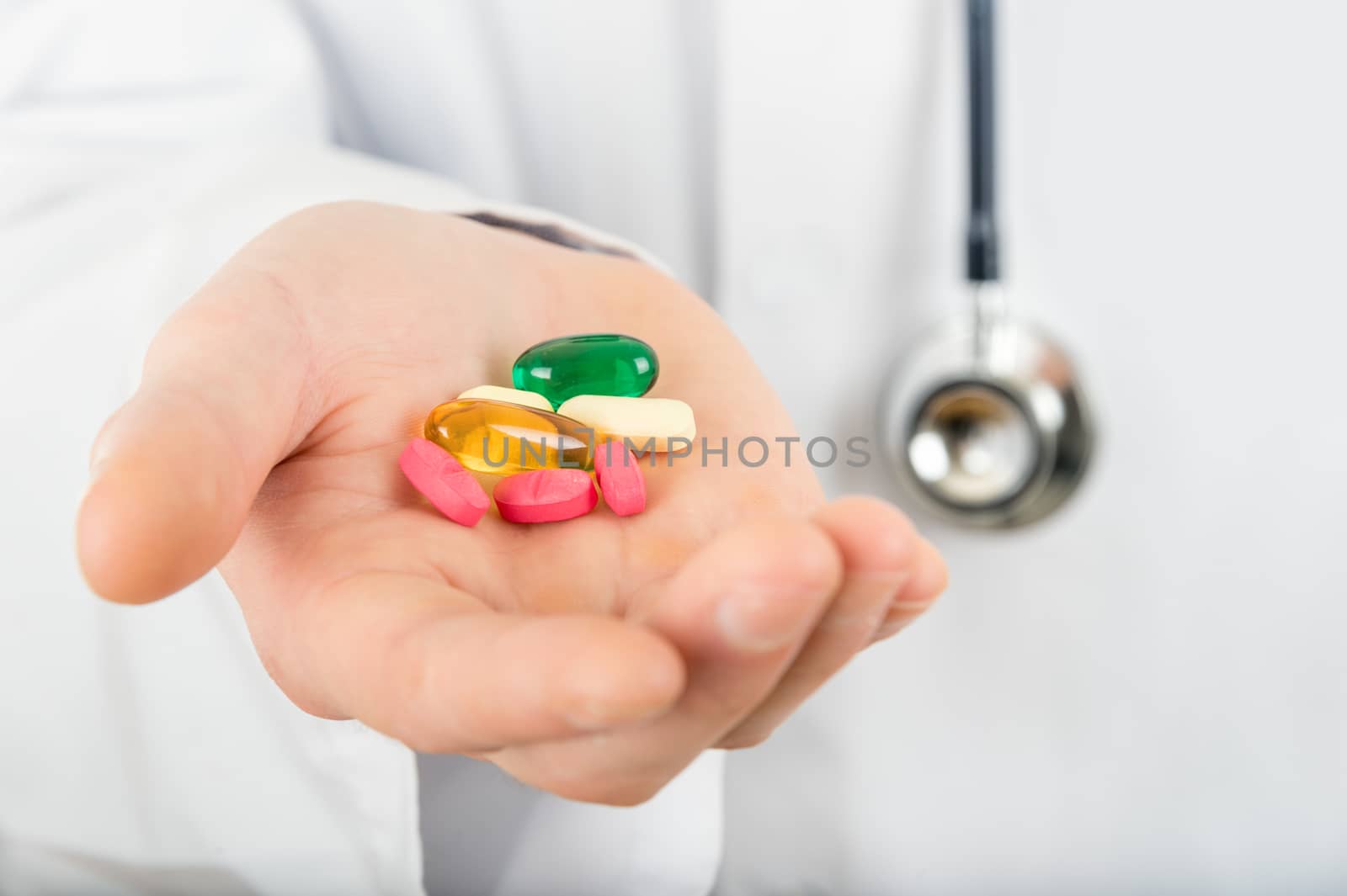 Hand of a doctor holding a drug pill by mbruxelle