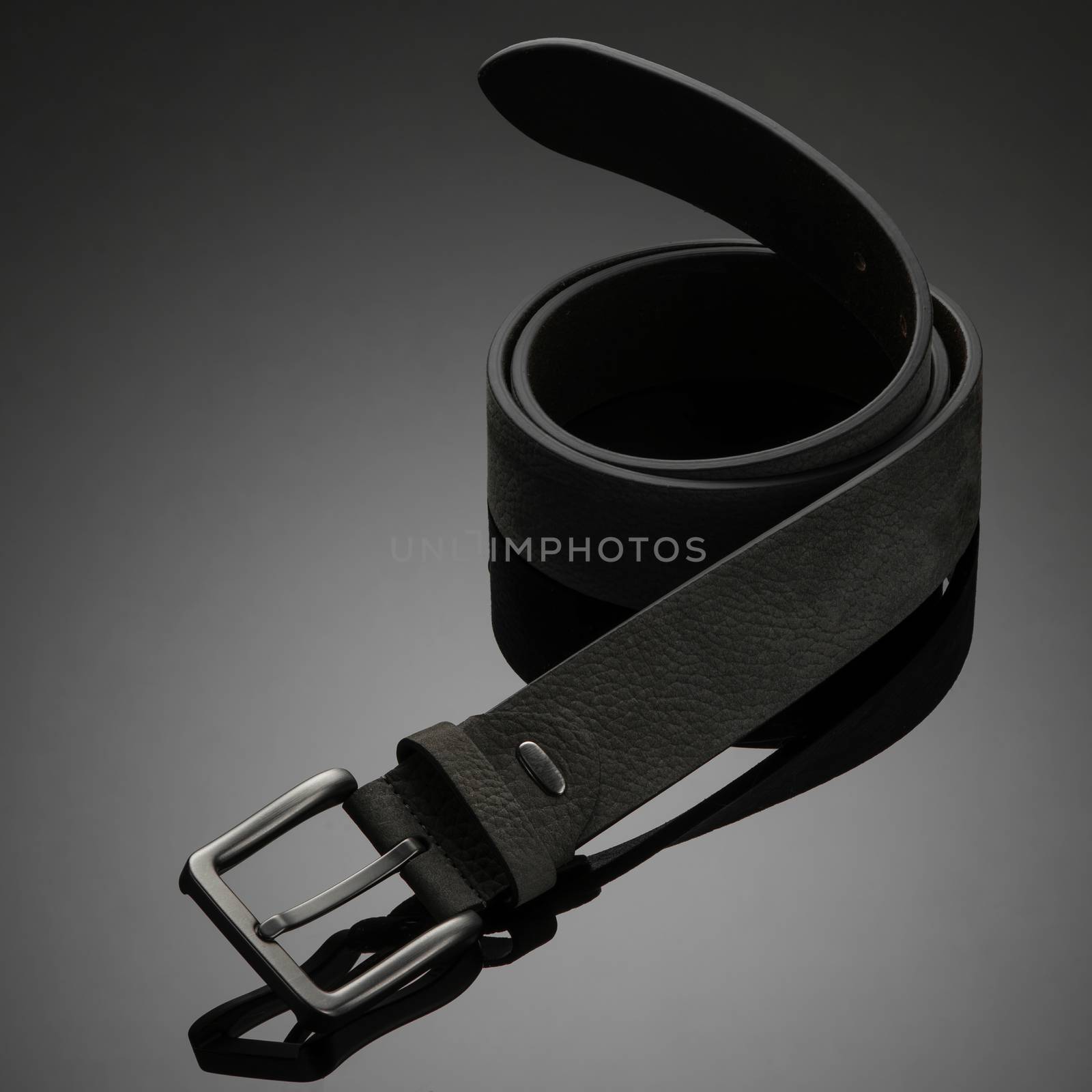 fashionable black leather men's belt on black background