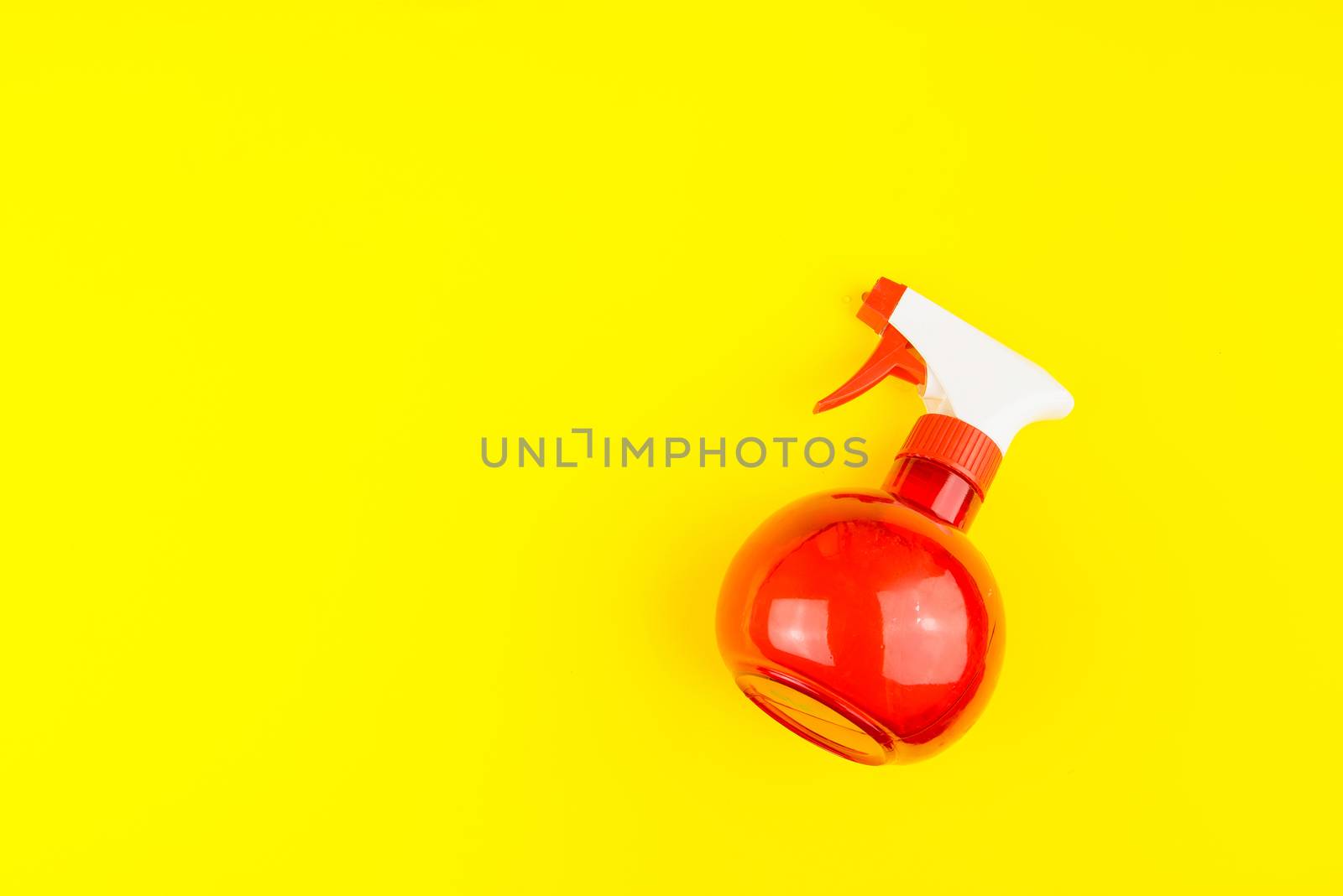 Hairdresser plastic water sprayer container on yellow background. Hairdresser salon concept, Hairdressing Set. Haircut accessories. Copy space image, flat lay