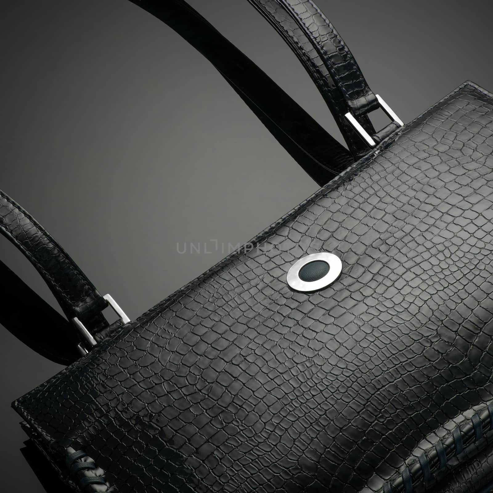 Black fashionable designer women's bag on a dark background