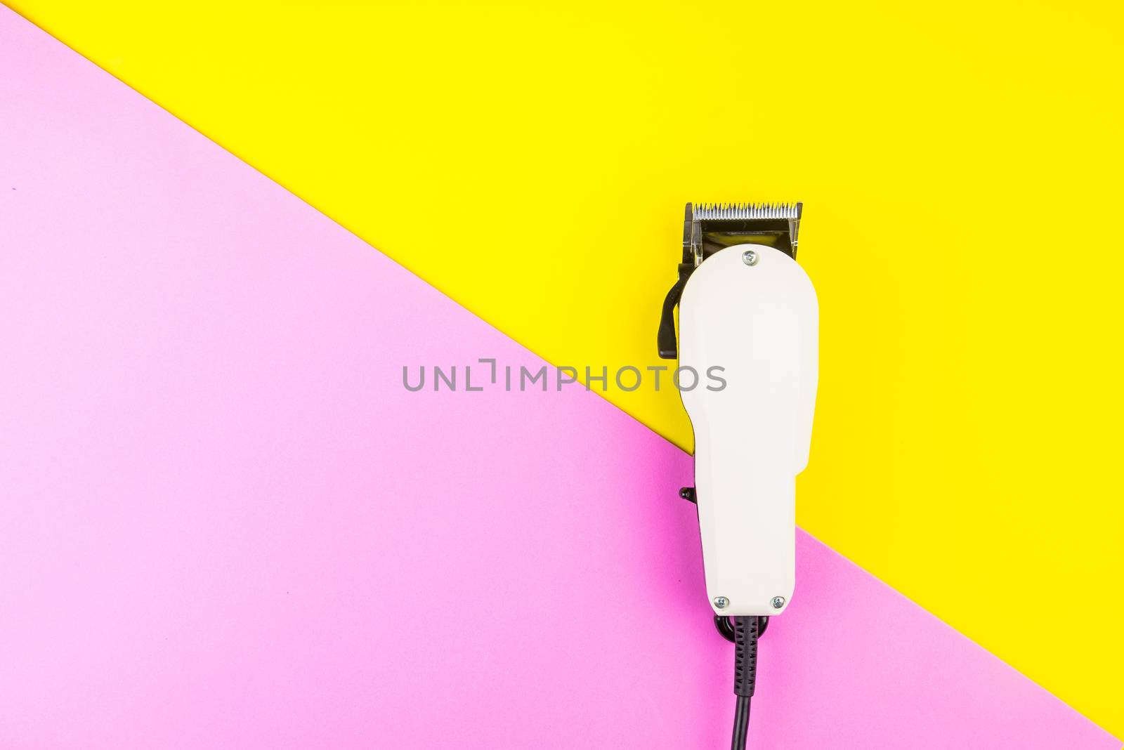 White electric clippers barber on yellow and pink background. Ha by Bubbers