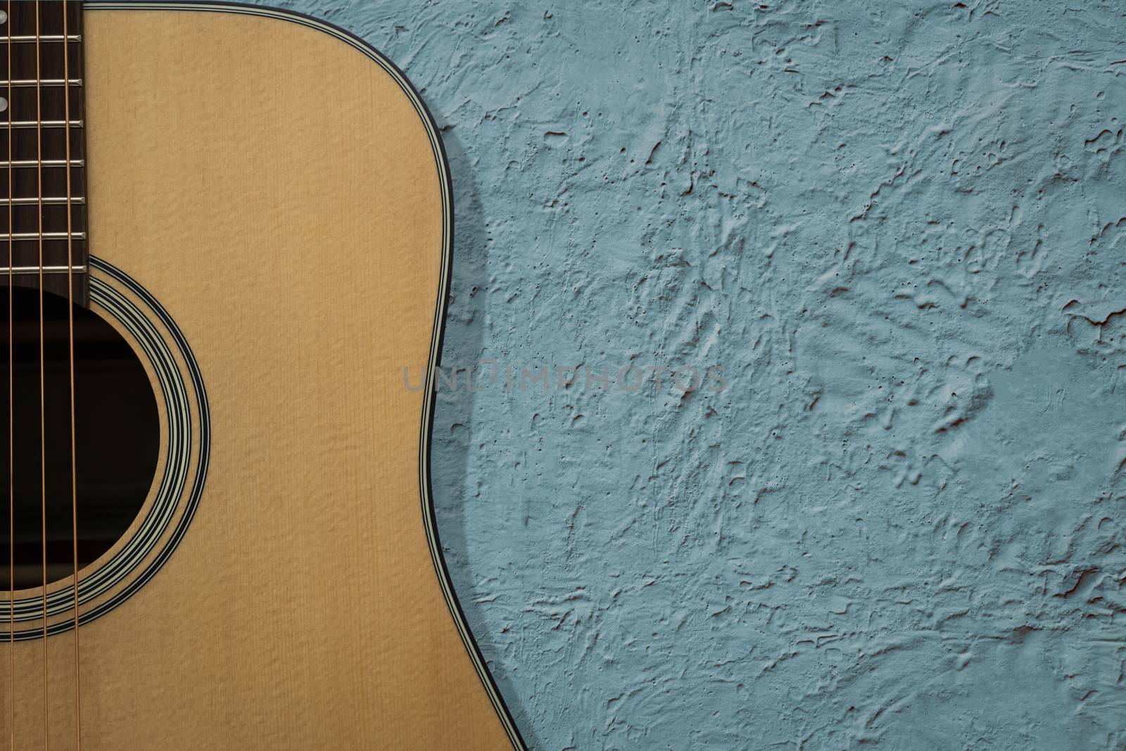 Guitar is a classic instrument on blue cement background with copy space.