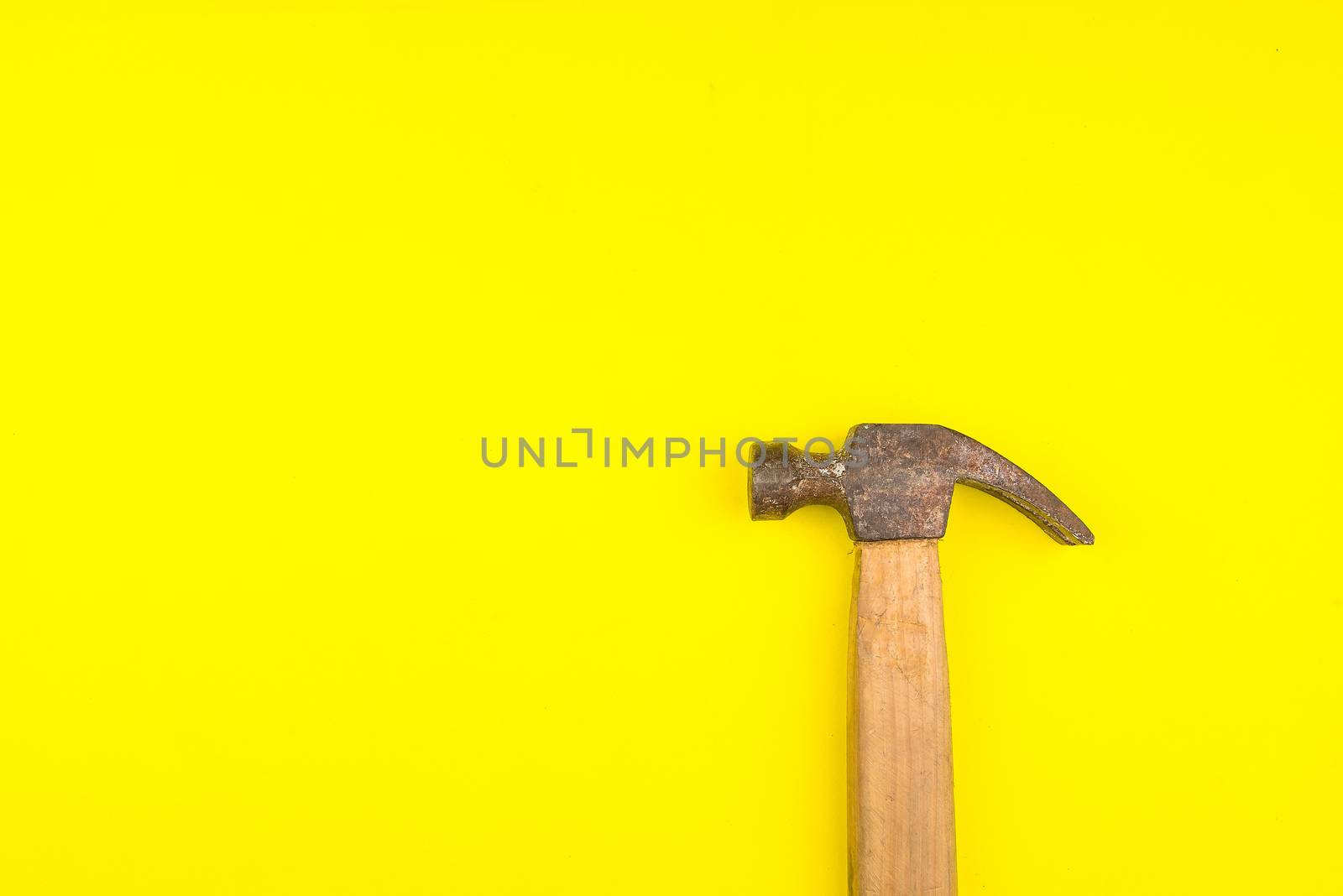 Top view of construction hammer on yellow background with copy s by Bubbers
