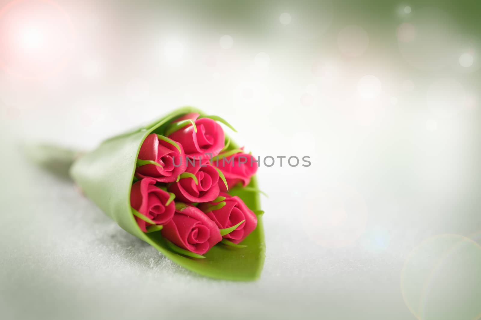 The red rose on abstract bokeh background in love concept for valentines day with romantic moment.