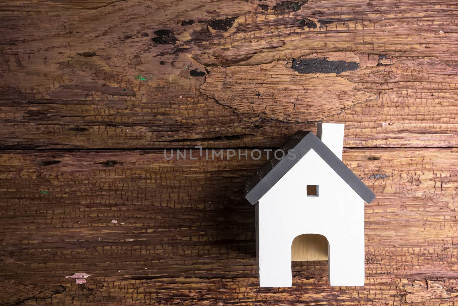 Wooden house on wooden background with copy space.Real estate co by Bubbers