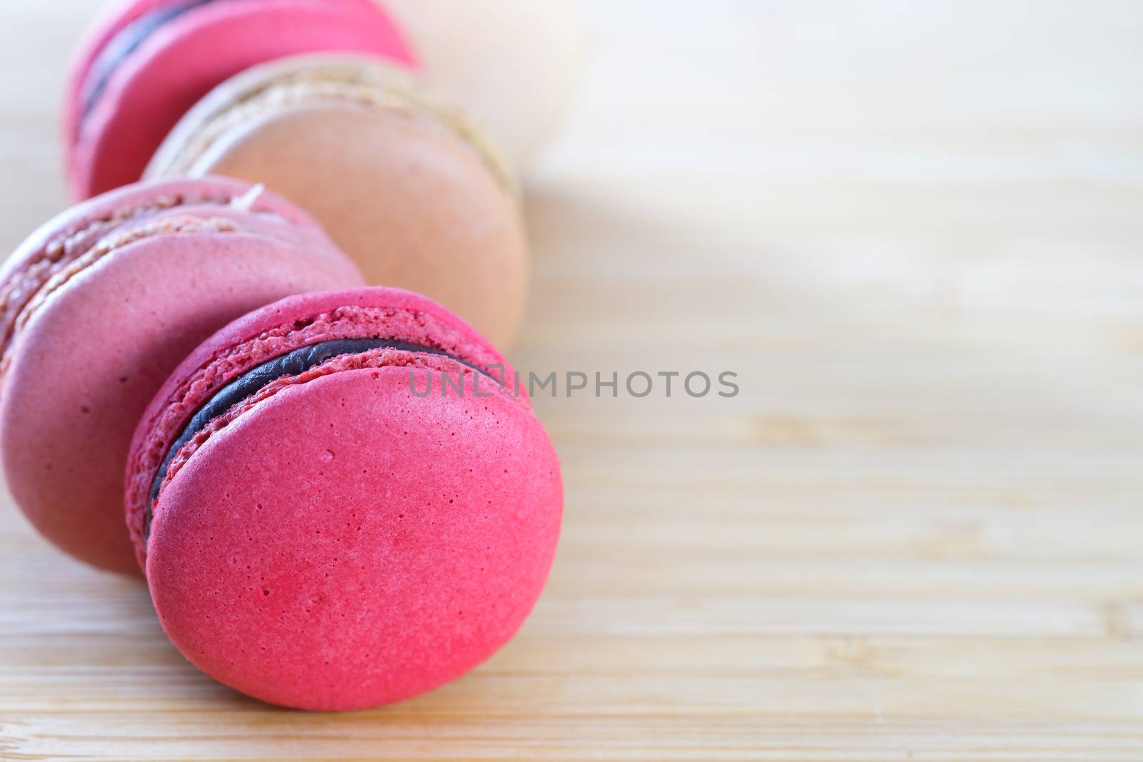 Sweet and colorful macaroons cookies on wooden background with blank space,selective focus, Dessert.