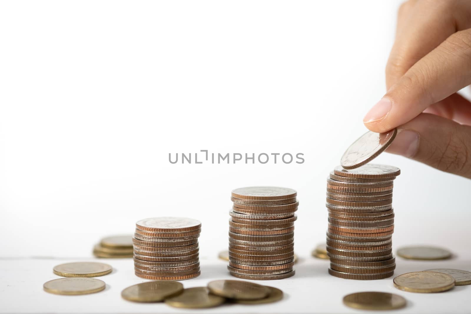 Hand stack coins,  concept for Saving money, growing business and wealthy.