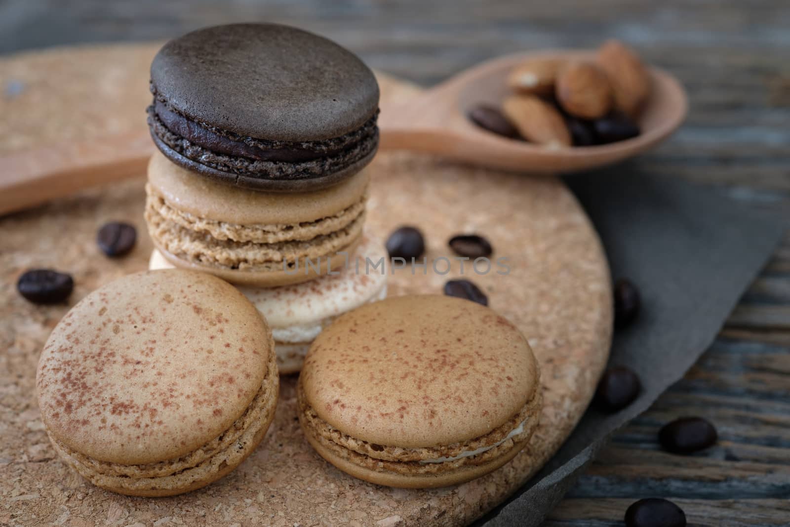 Chocolate and coffee macaroons  on wooden background in low light, AF point selection, copy space for write.