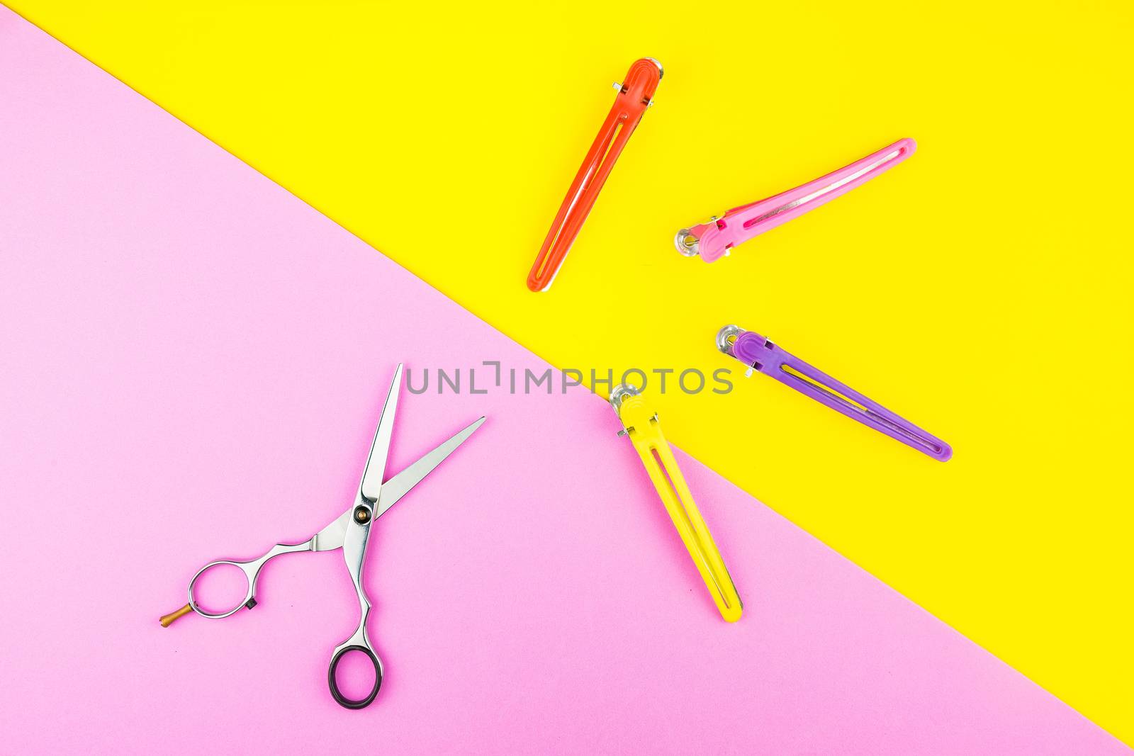 Stylish Professional Barber Scissors on yellow and pink background. Hairdresser salon concept, Hairdressing Set. Haircut accessories. Copy space image, flat lay