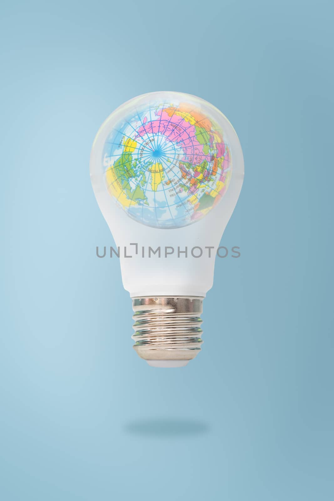 Blue world map in light bulb isolated on white background, symbo by feelartfeelant