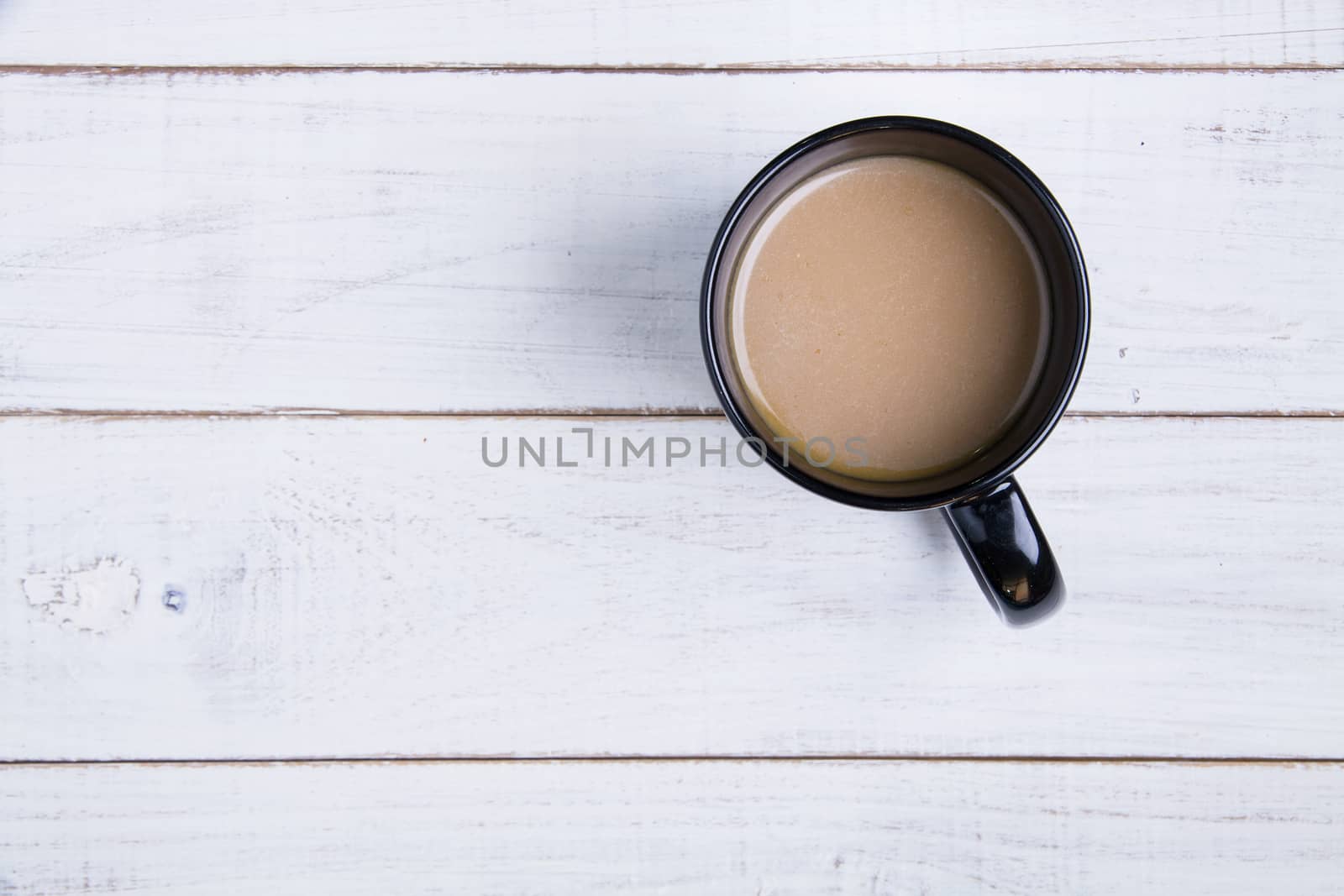 Coffee cup on the white wooden background.