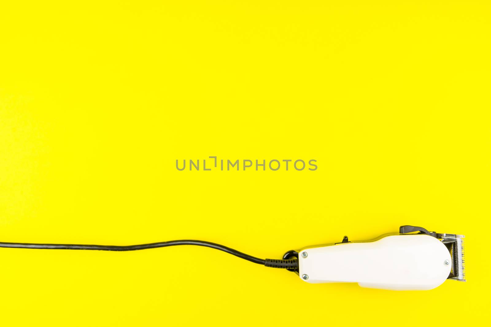 White electric clippers barber on yellow background. Hairdresser salon concept, Hairdressing Set. Haircut accessories. Copy space image, flat lay