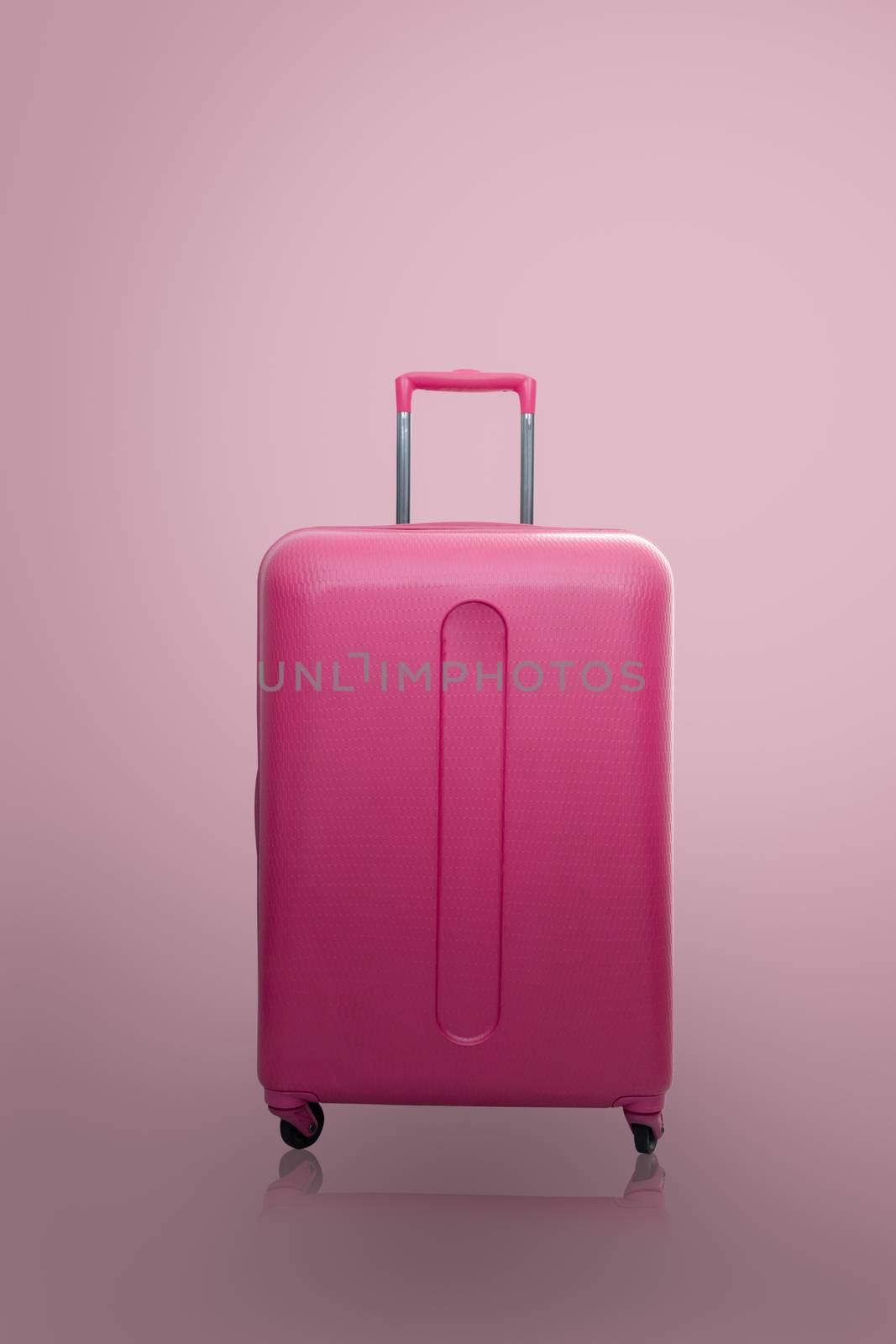 Traveler pink suitcase or cabin size luggage on pink background with shadow, Journey and travel concept.