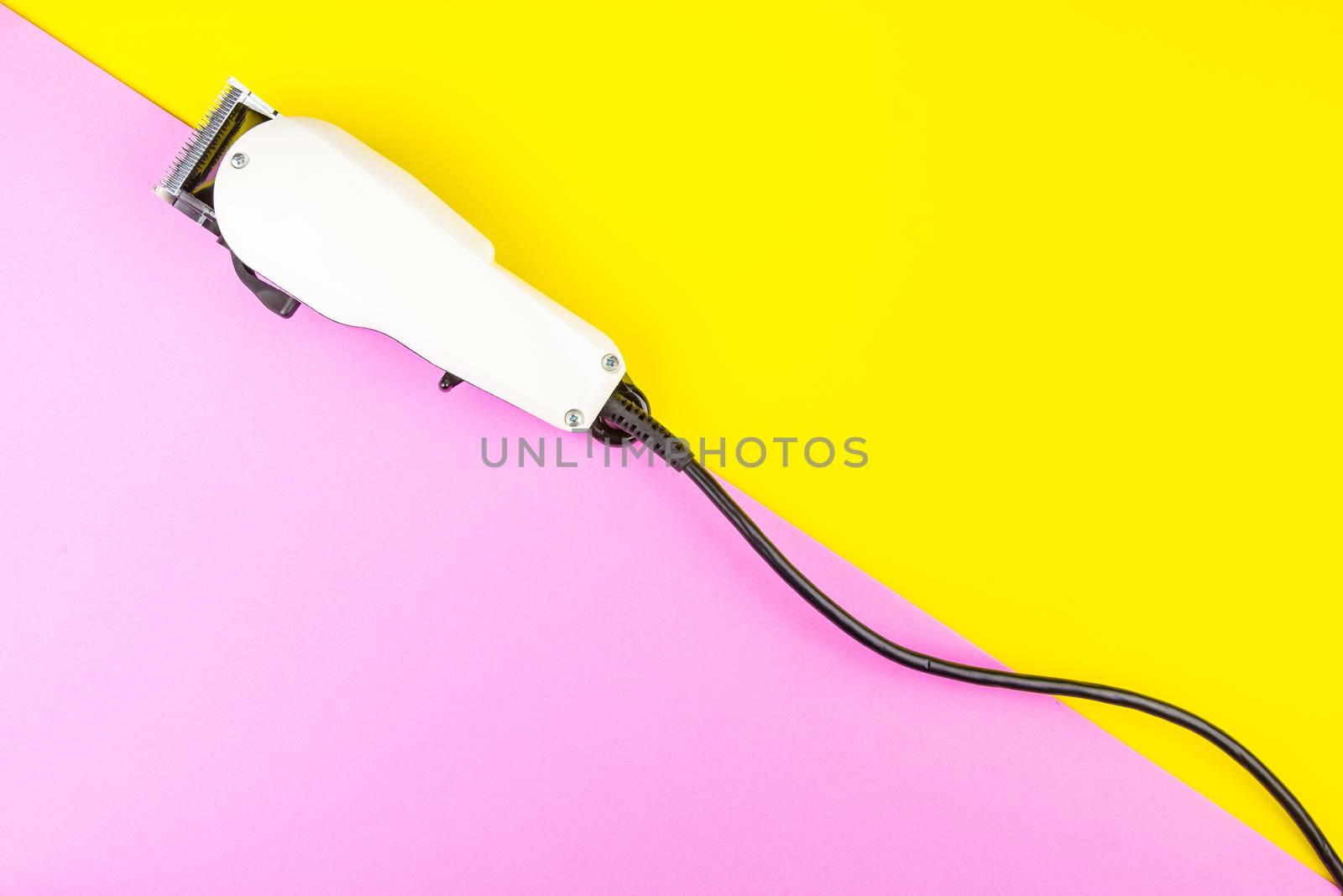 White electric clippers barber on yellow and pink background. Ha by Bubbers