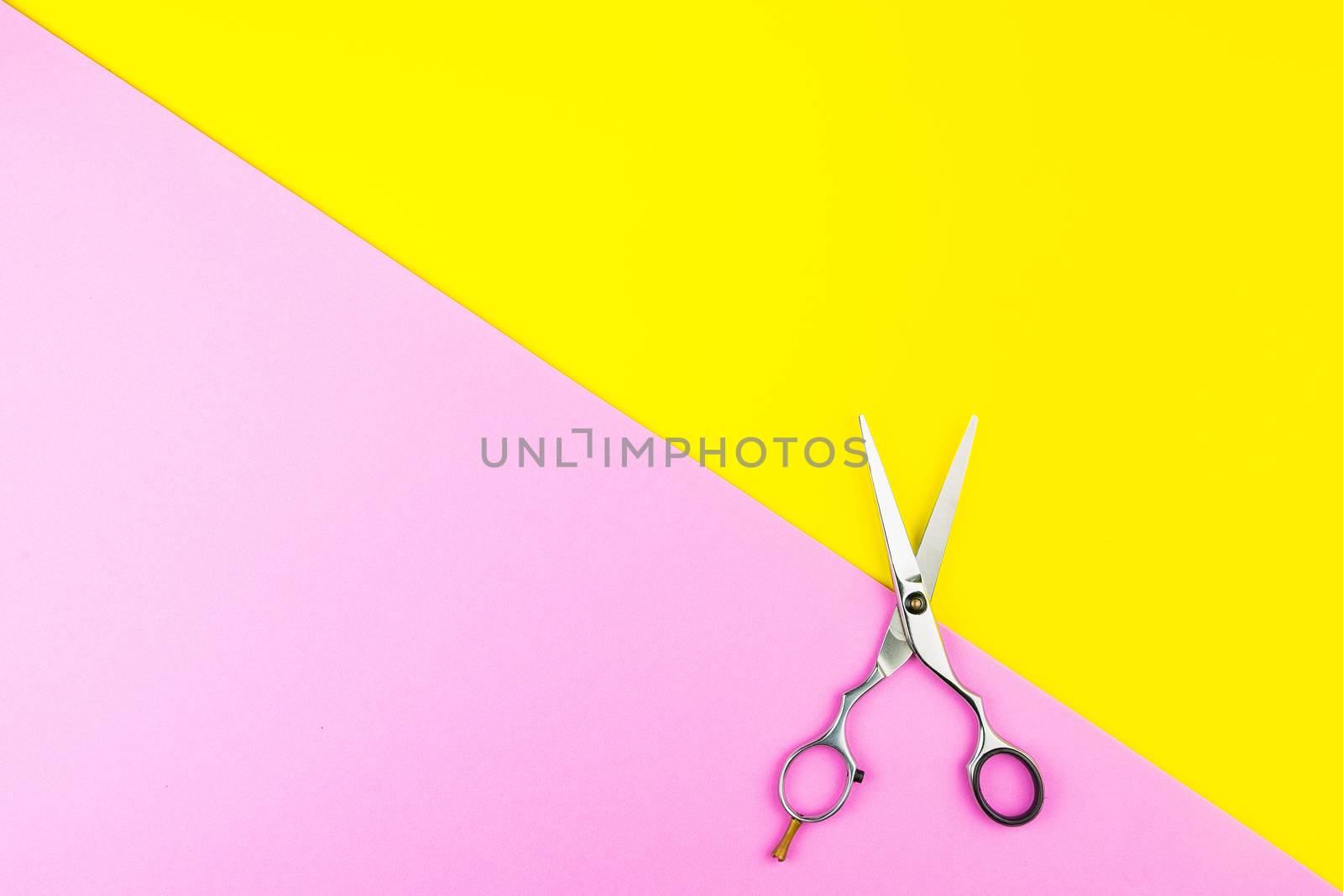 Stylish Professional Barber Scissors on yellow and pink background. Hairdresser salon concept, Hairdressing Set. Haircut accessories. Copy space image, flat lay