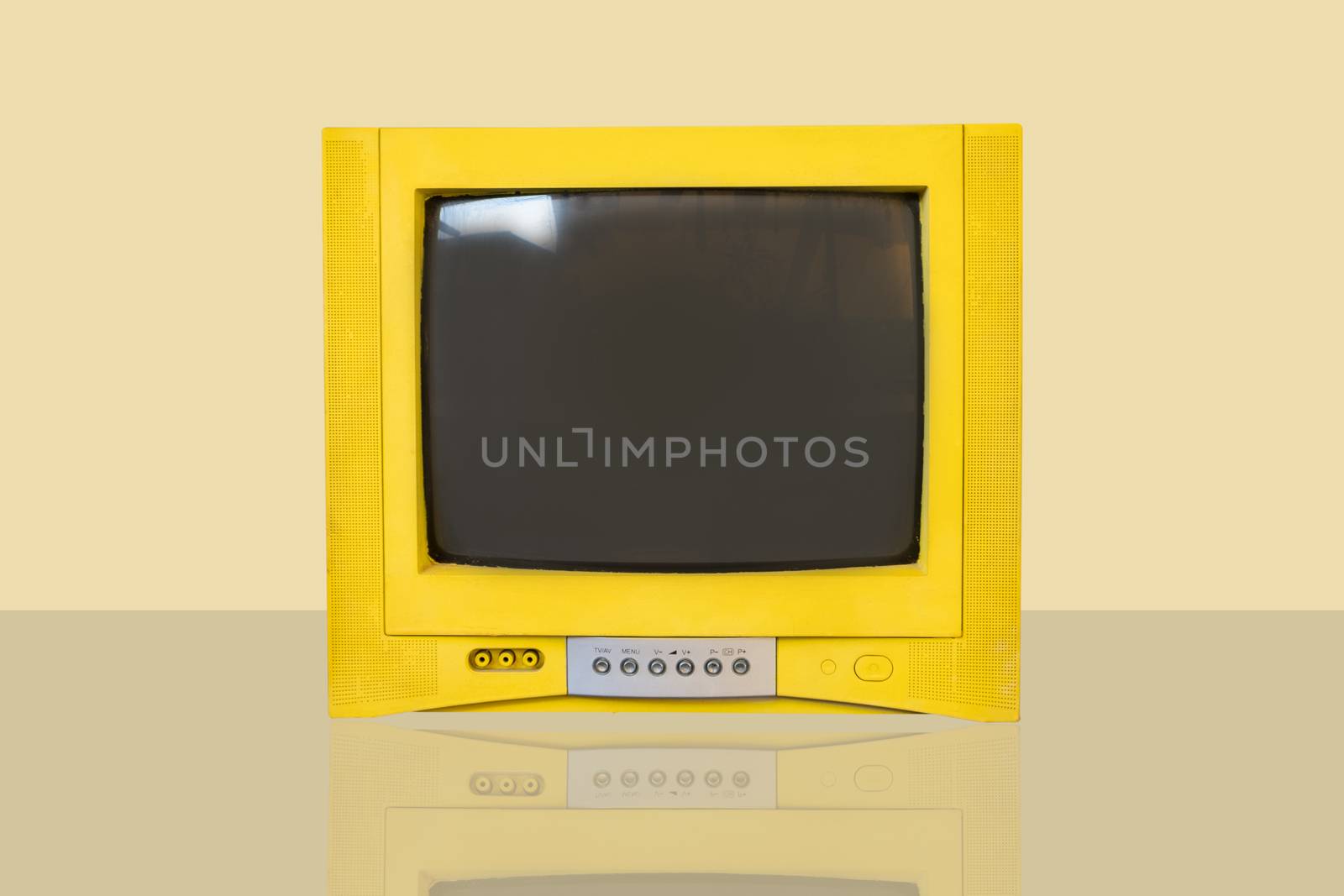 Retro old television from 80s on yellow background with shadow.