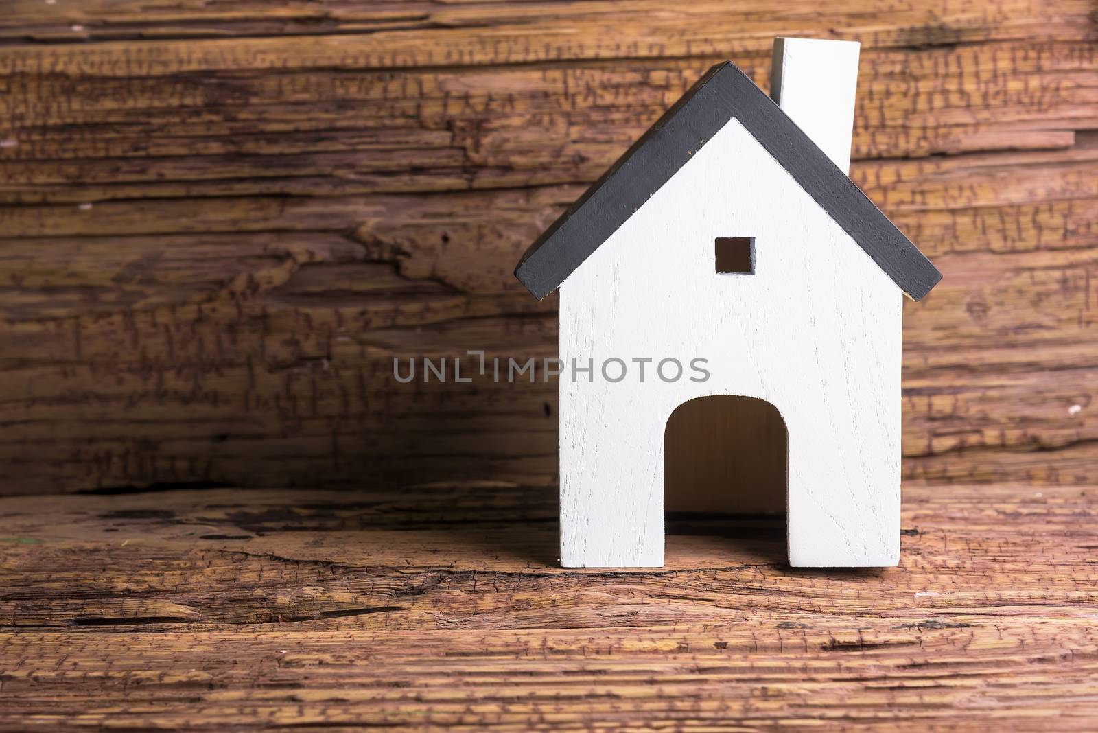 Wooden house on wooden background with copy space.Real estate co by Bubbers