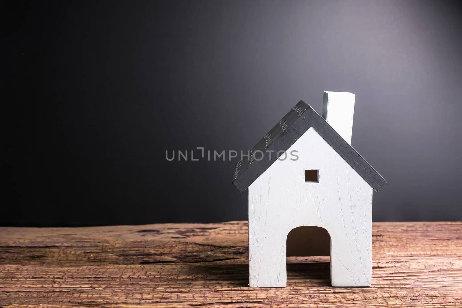 Wooden house on black background with copy space.Real estate con by Bubbers