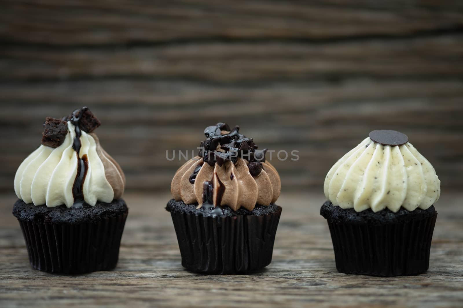 Tasty mini cupcakes on a vintage background, sweet dessert for christmas, new year and valentine holliday.