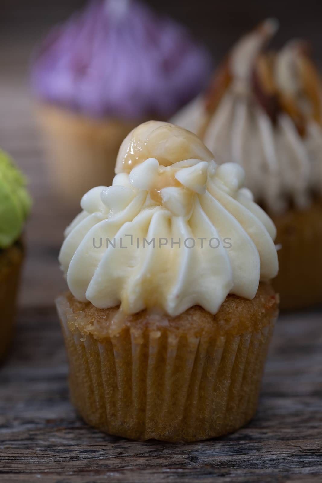 Tasty mini cupcakes on a vintage background, sweet dessert for christmas, new year and valentine holliday.