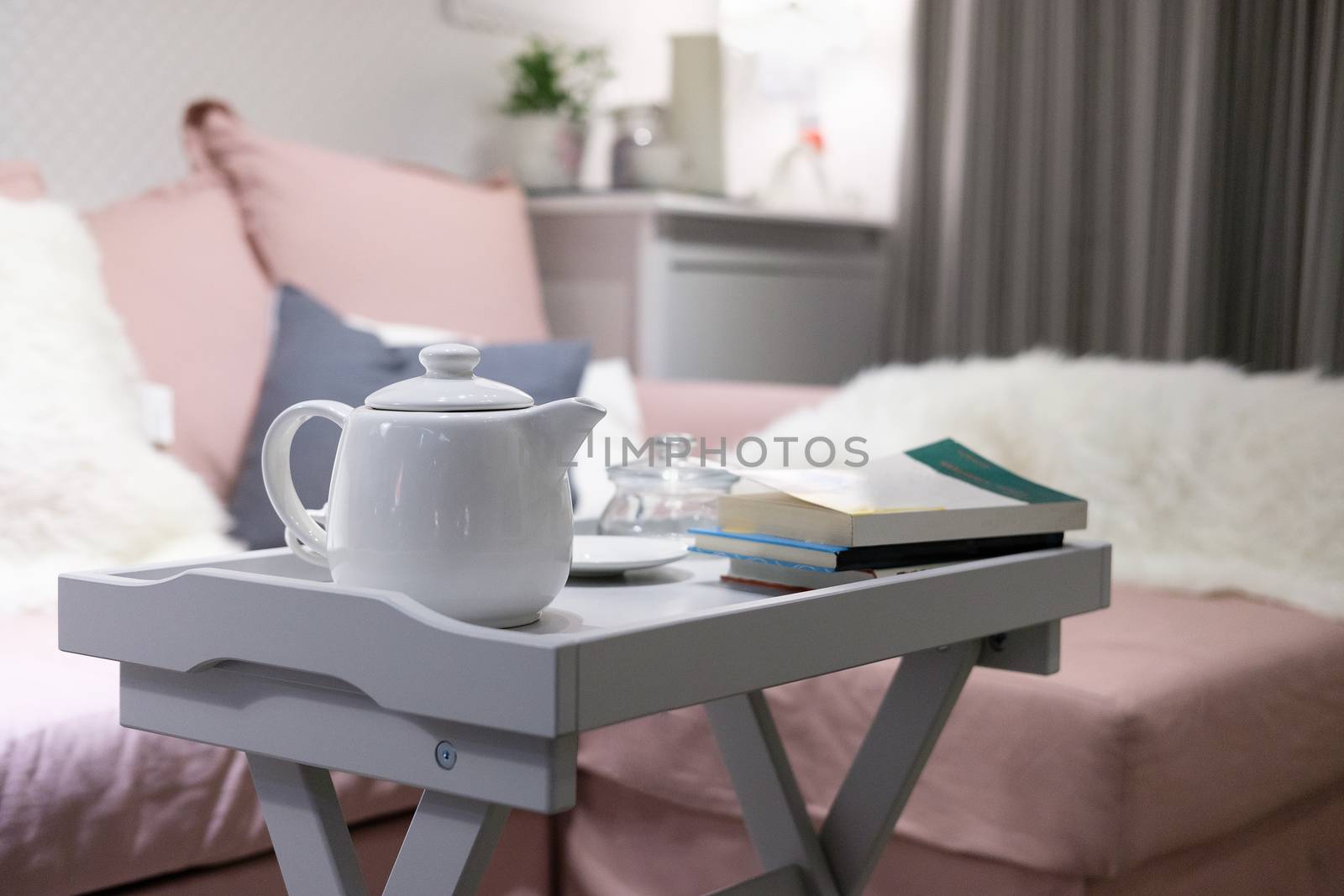 White teapot on the table in living room.