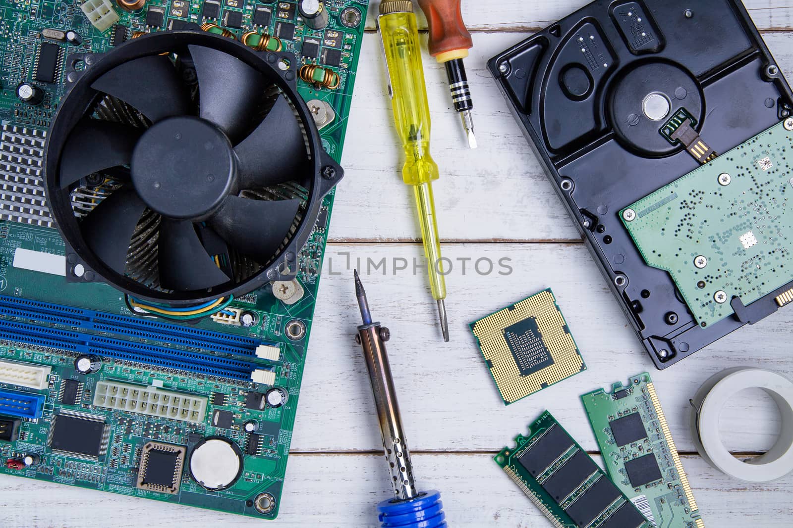 Computer motherboard, Computer Parts, Hard disk, Ram and equipment repair on the white wooden background.