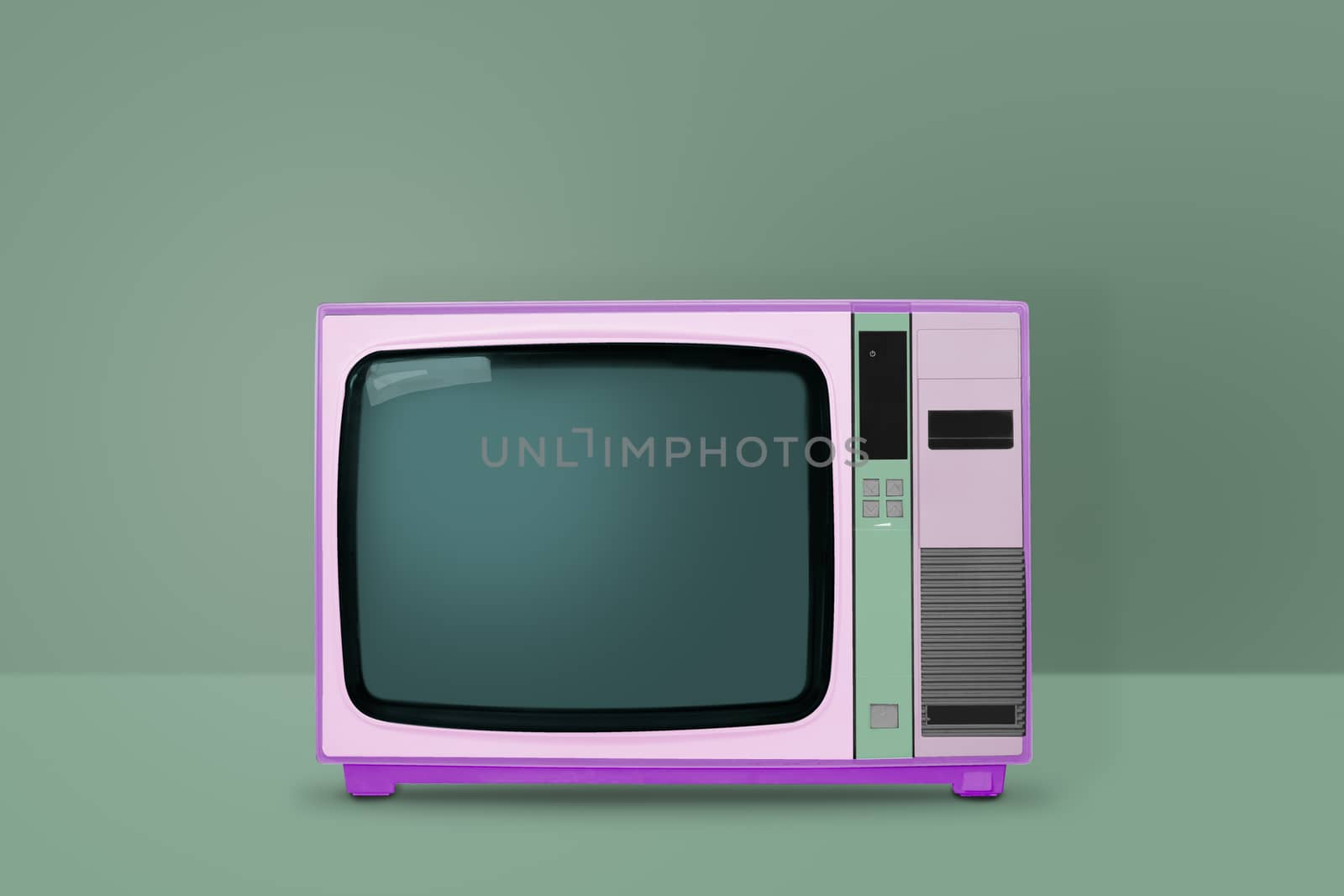 Retro pastel pink TV on green background.  vintage and minimalism style.