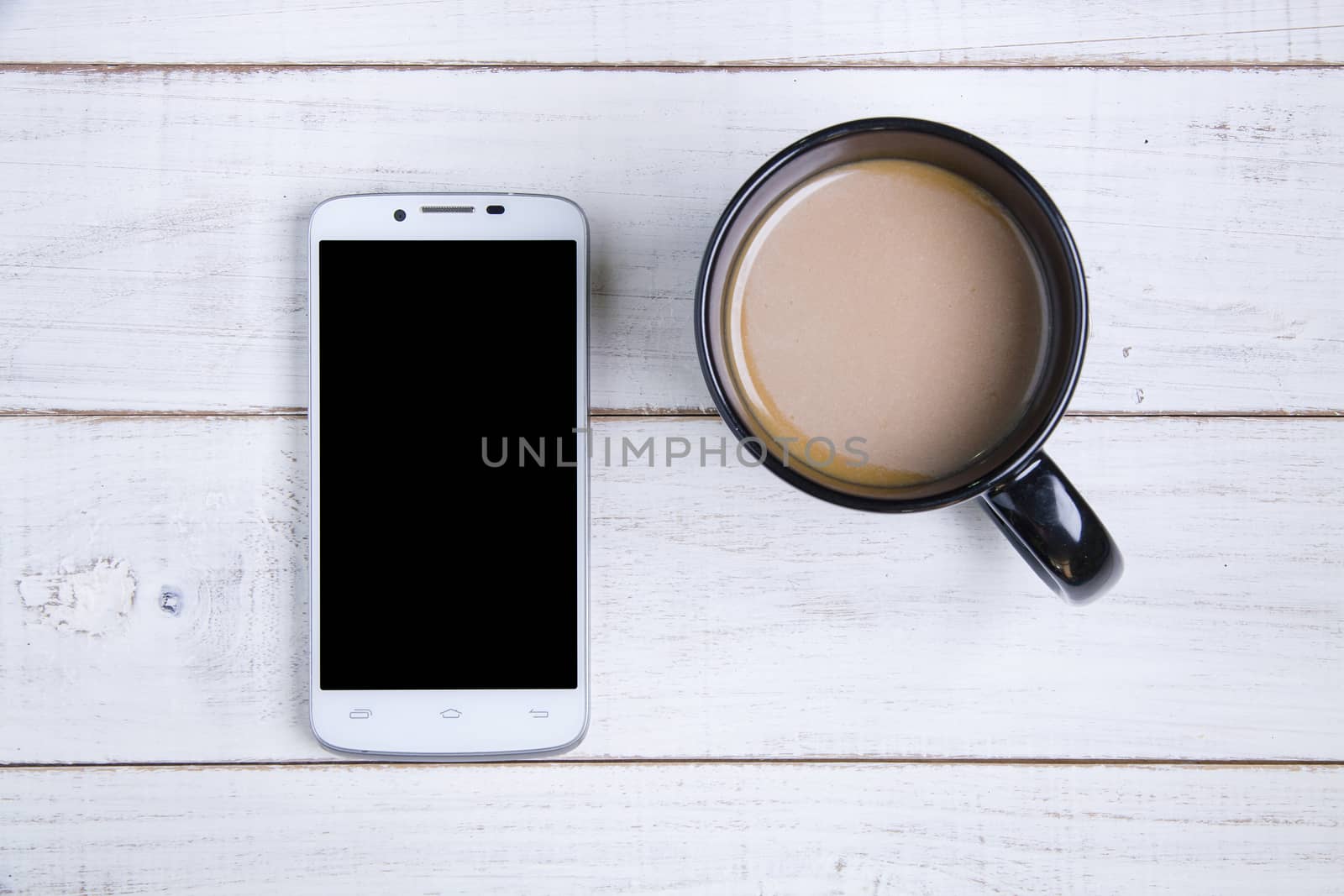 smartphone and coffee cup on the white wooden background. by Bubbers