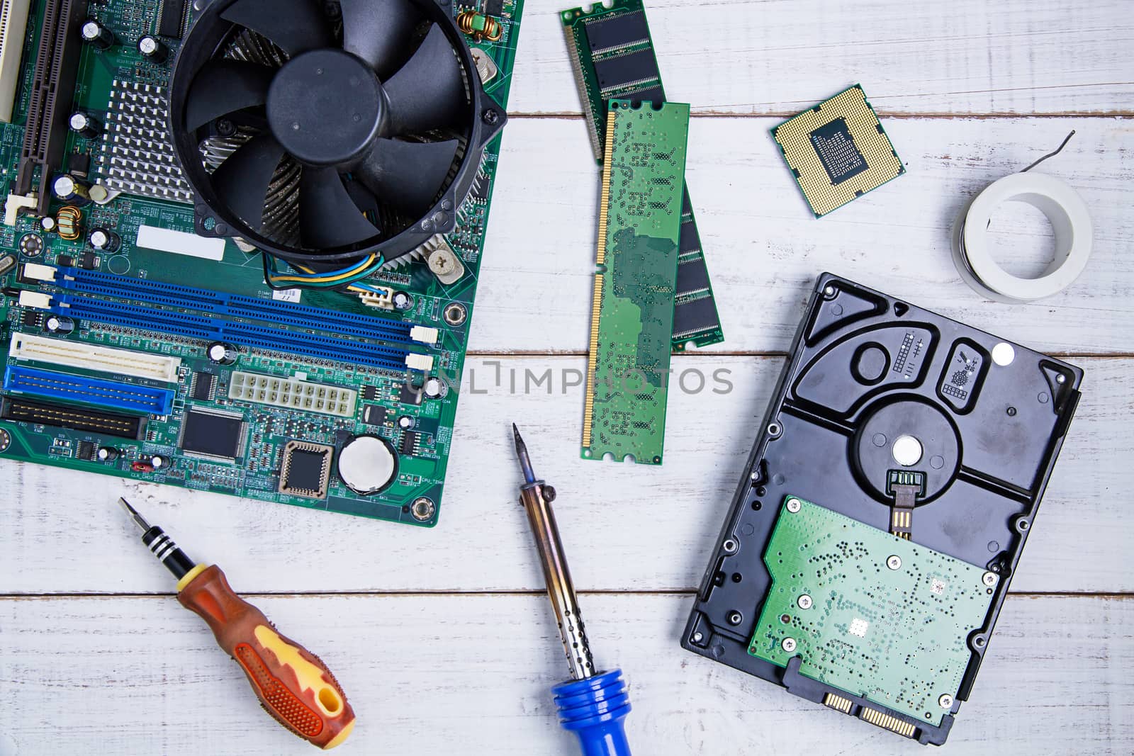 Computer motherboard, Computer Parts, Hard disk, Ram and equipment repair on the white wooden background.