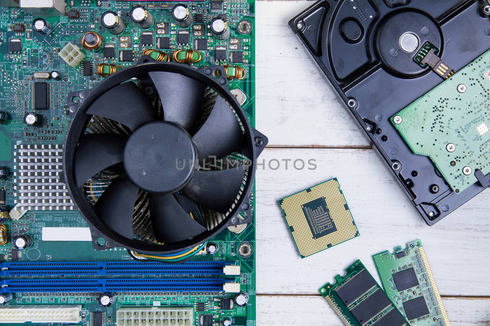 Computer motherboard, Computer Parts, Hard disk, Ram and equipment repair on the white wooden background.