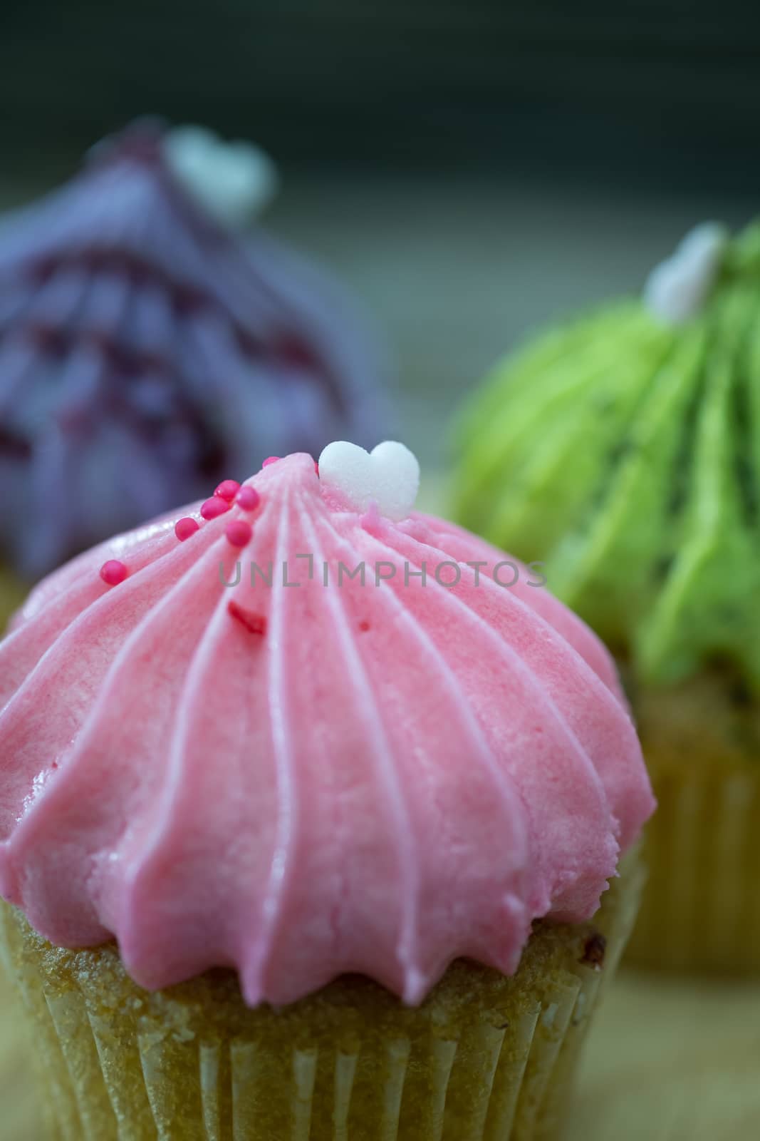 Tasty mini cupcakes on a vintage background, sweet dessert for christmas, new year and valentine holliday.