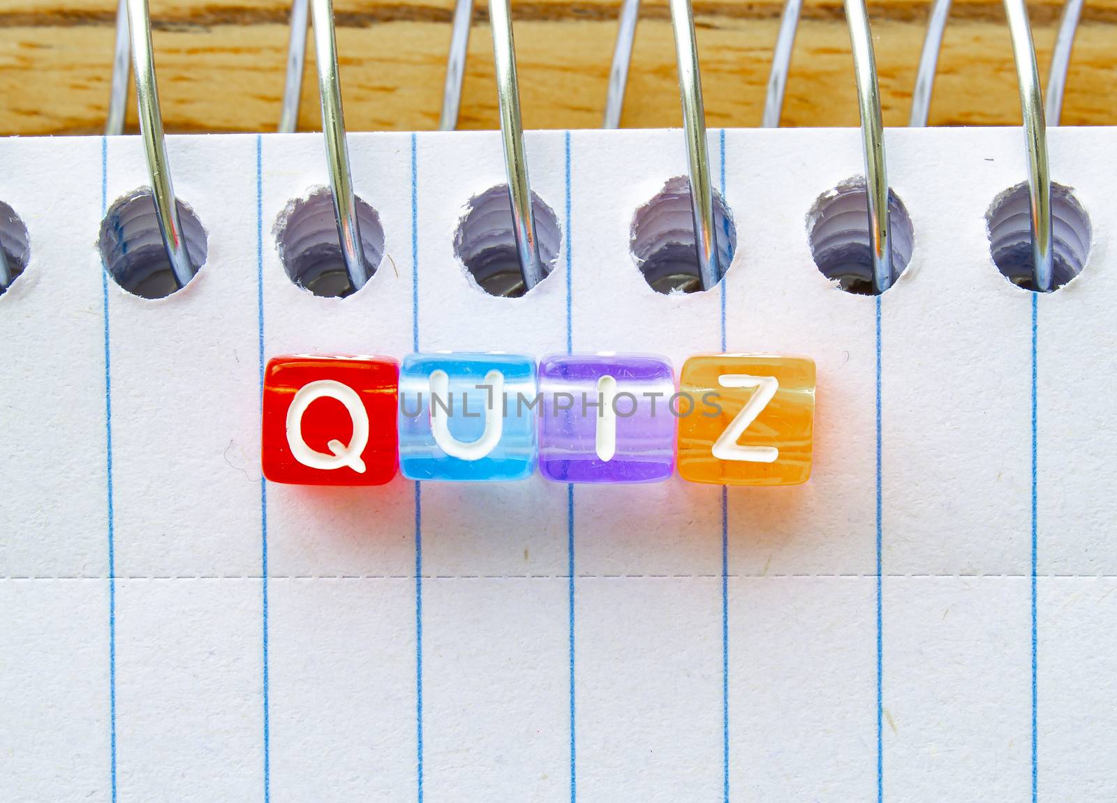 Quiz, message in text on colorful cubes on a notebook by oasisamuel